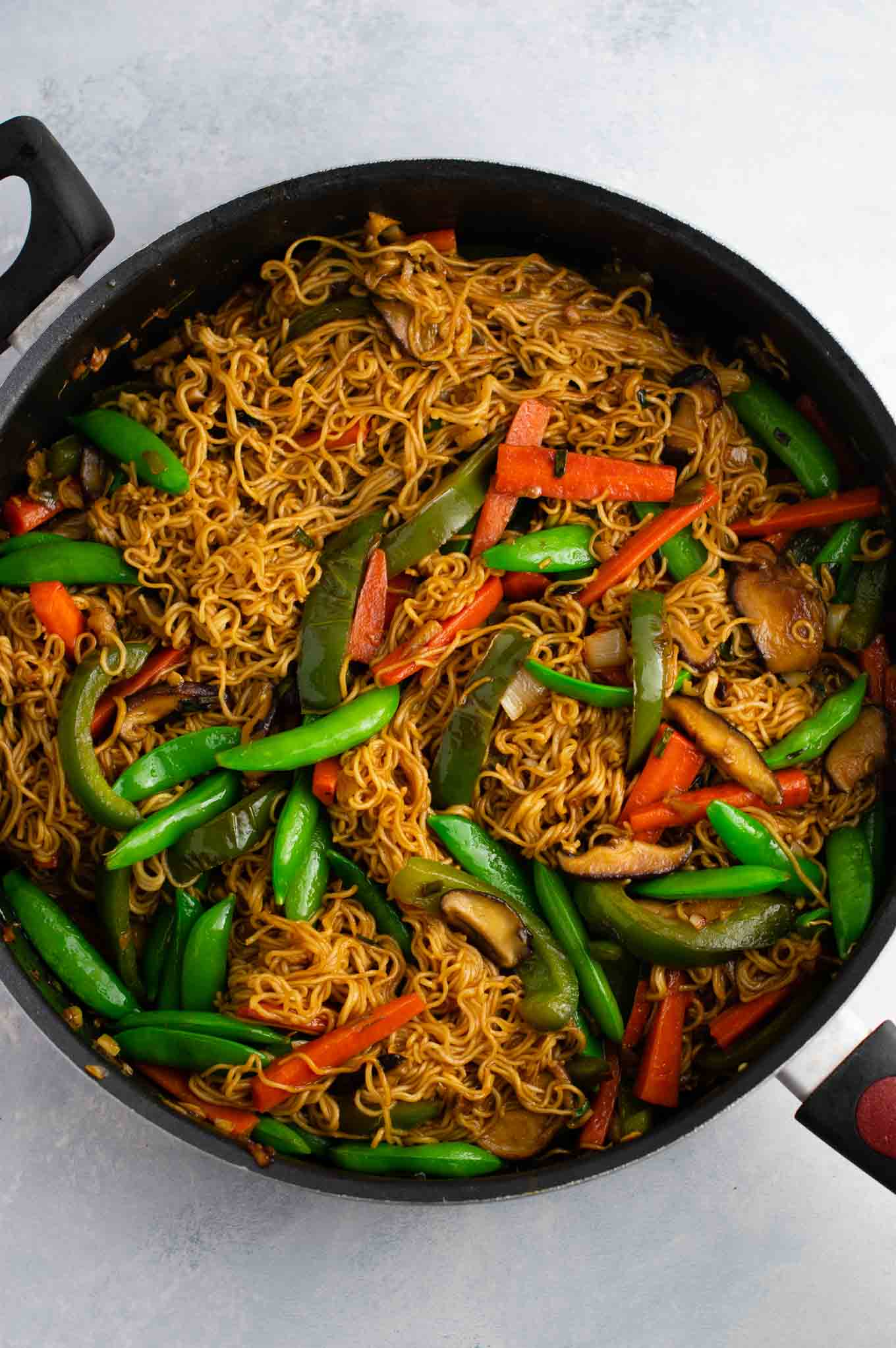 Ramen noodle stir fry with golden oak shitake mushrooms, sugar snap peas, green bell pepper, carrots, green onions, and fresh garlic and ginger. 