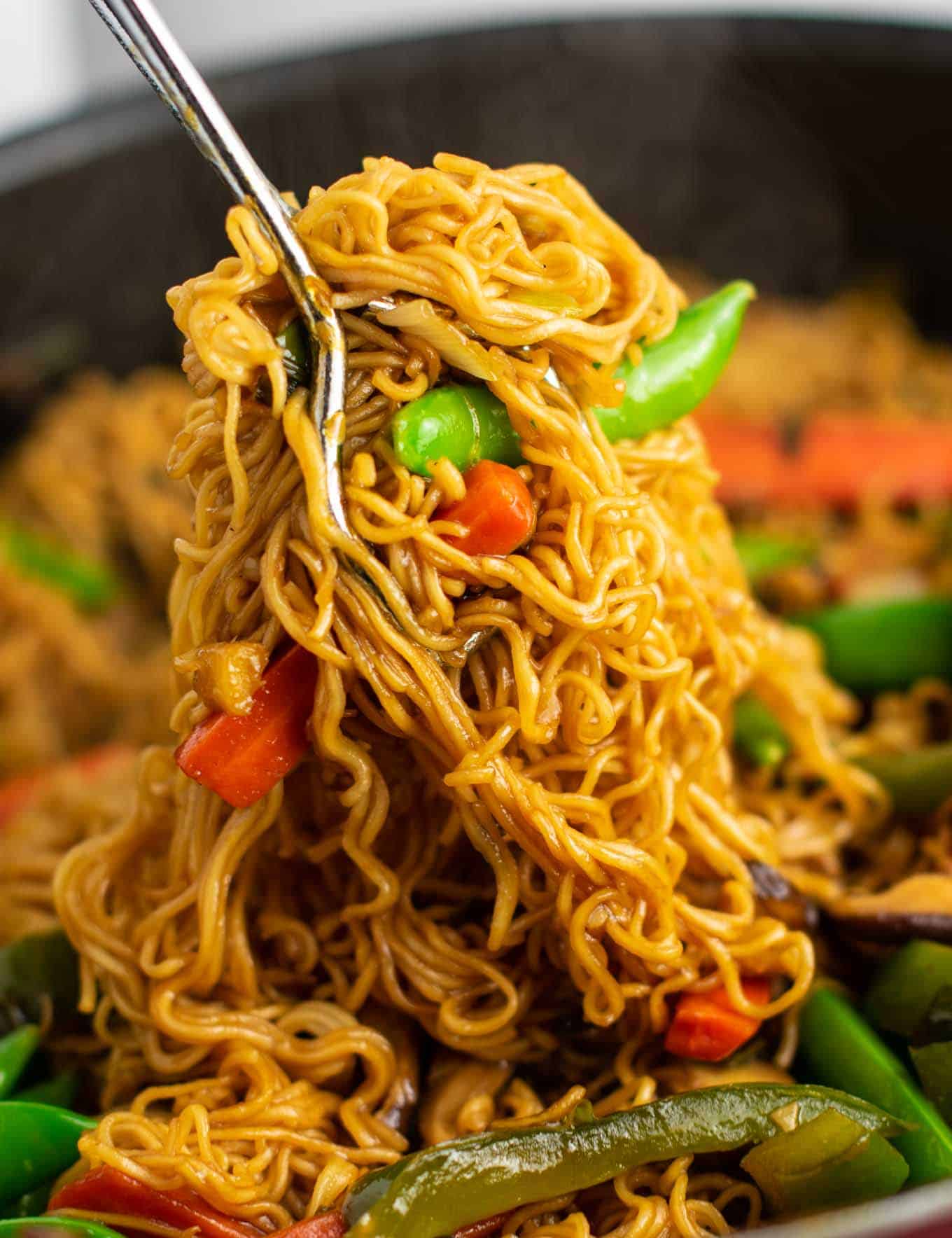 Ramen noodle stir fry with golden oak shitake mushrooms, sugar snap peas, green bell pepper, carrots, green onions, and fresh garlic and ginger.