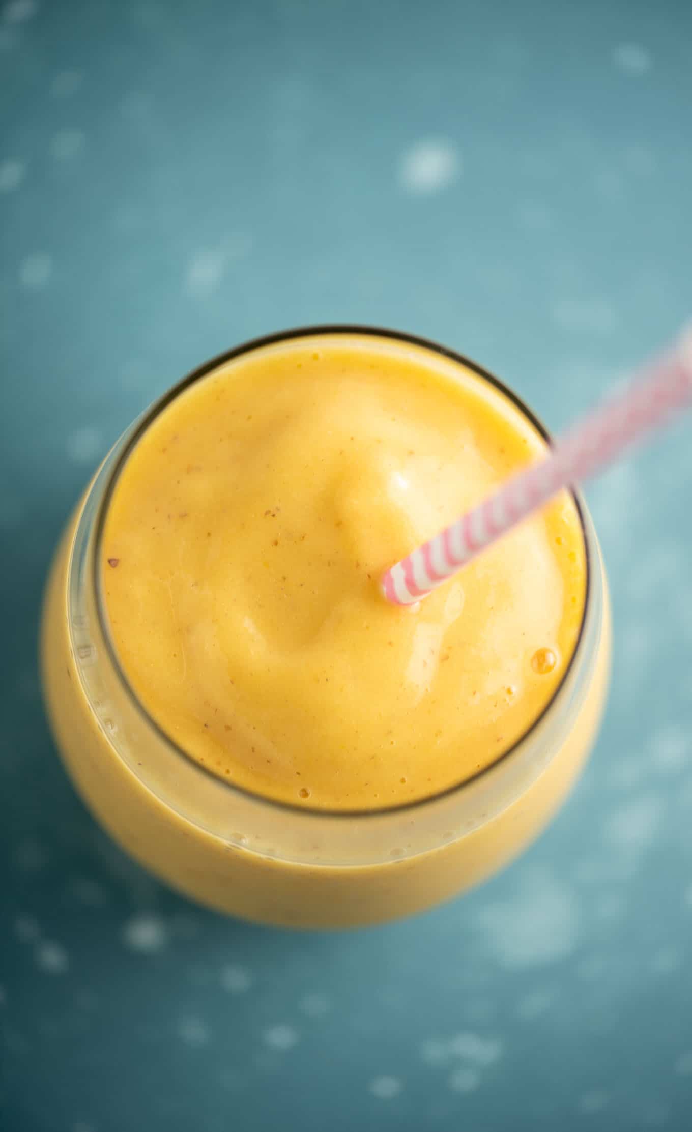 mango smoothie up close to show the thickness