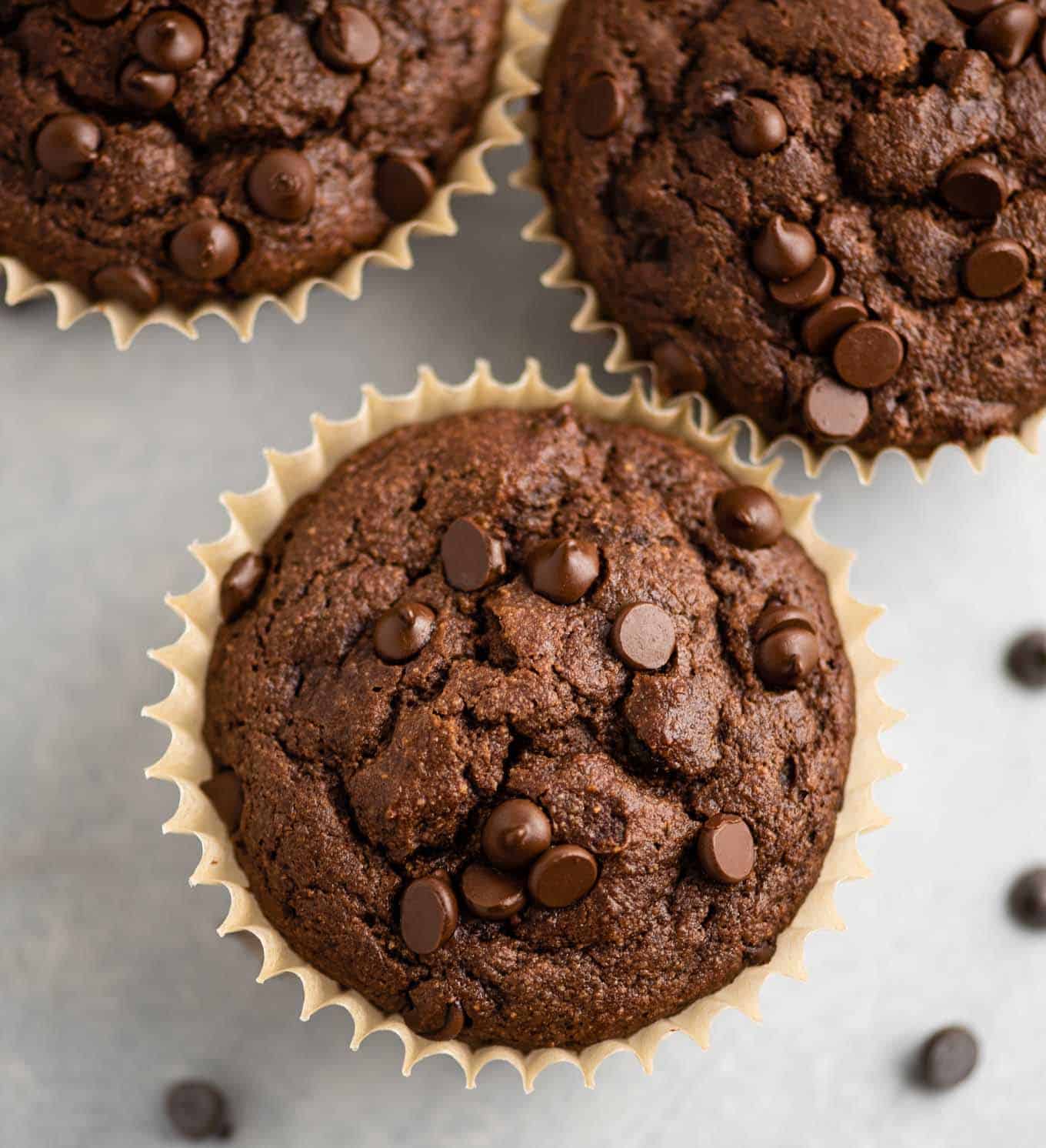 gluten free chocolate muffins from an overhead view topped with melted mini chocolate chips