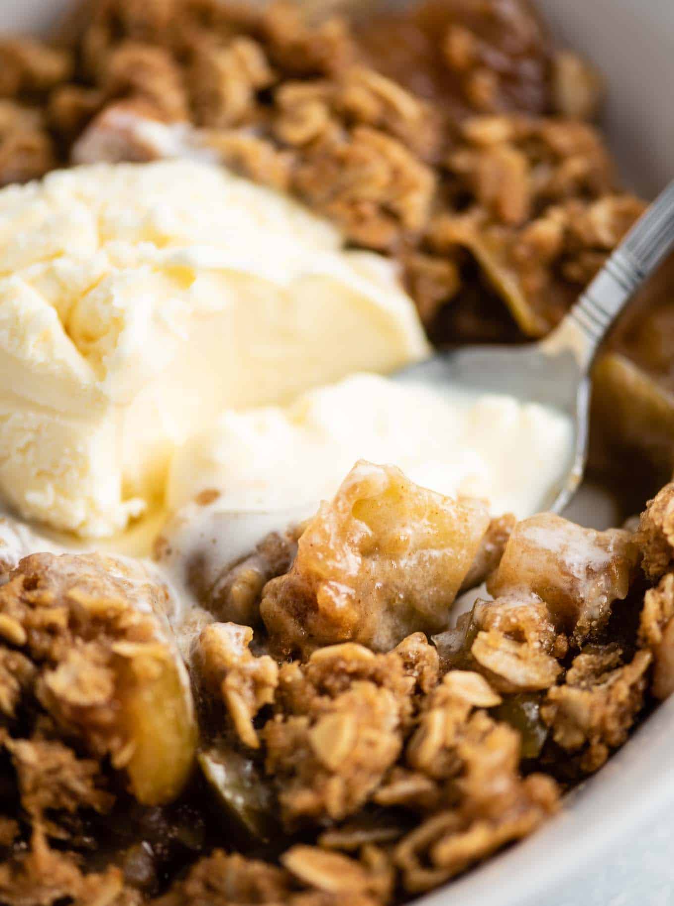 apple crisp with a spoon in the bowl