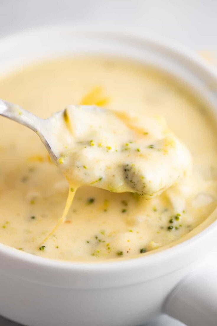 a spoonful of cheddar cheese and broccoli soup