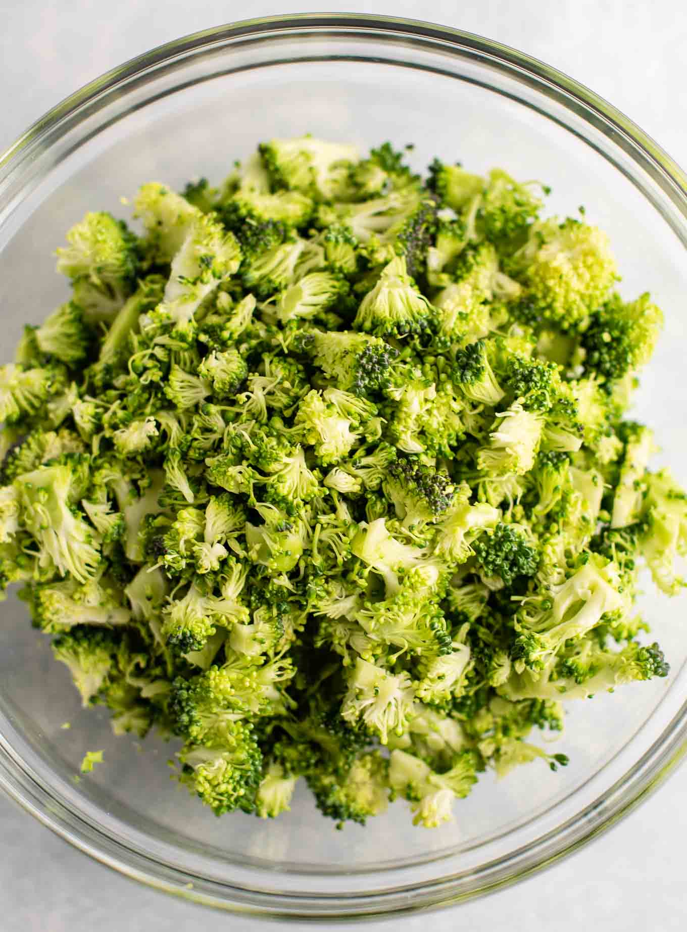 chopped up fresh broccoli in a clear bowl