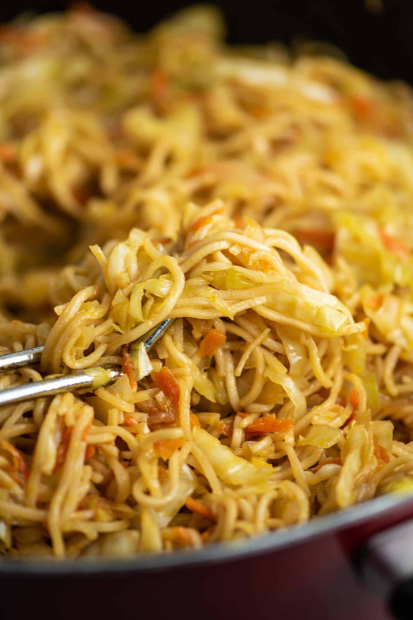 ramen noodle cabbage stir fry in a red pan