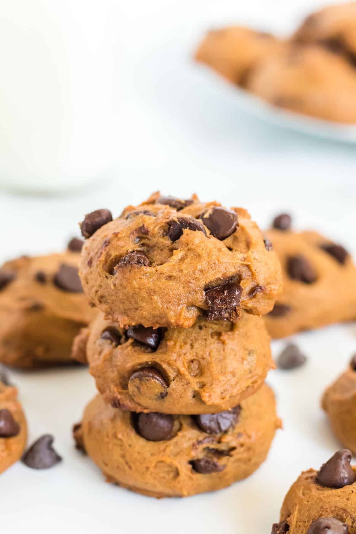 pumpkin chocolate chip cookies stacked on top of each other