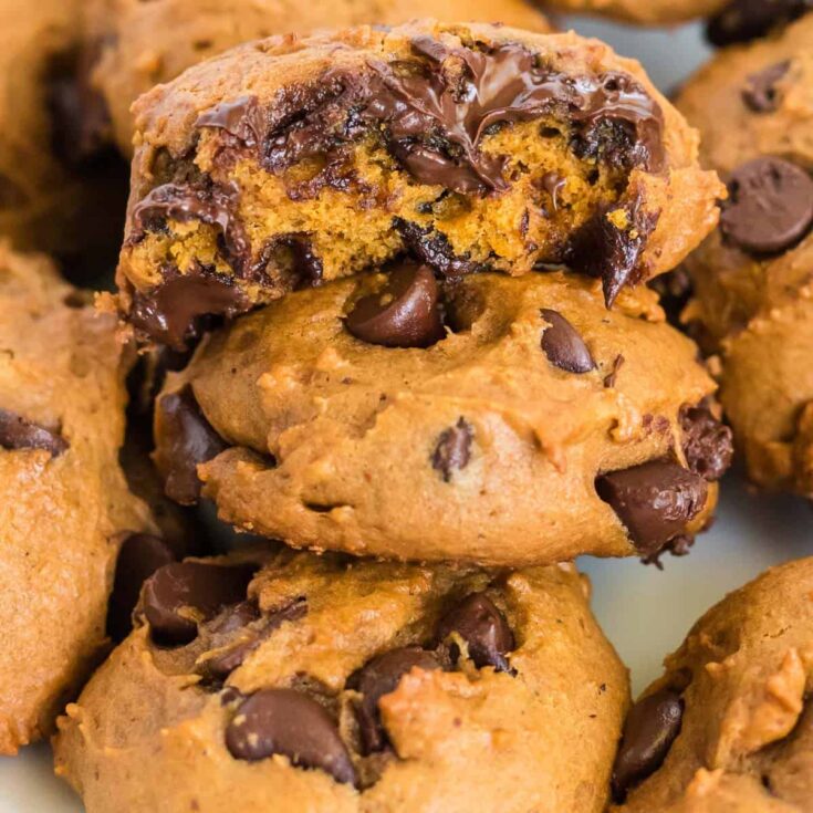 pumpkin chocolate chip cookies stacked on top of each other