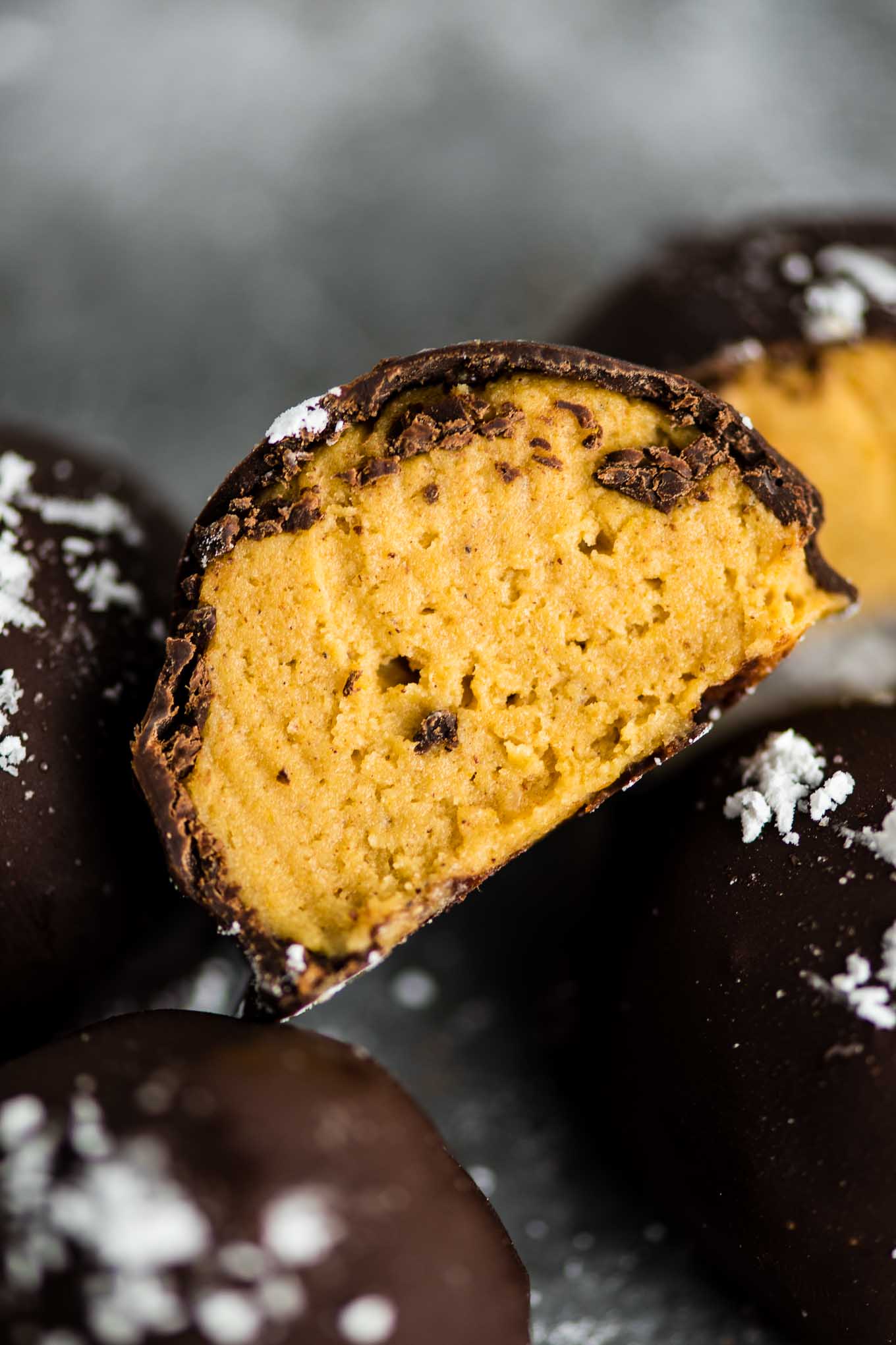 pumpkin truffle cut in half to show the cheesecake filling
