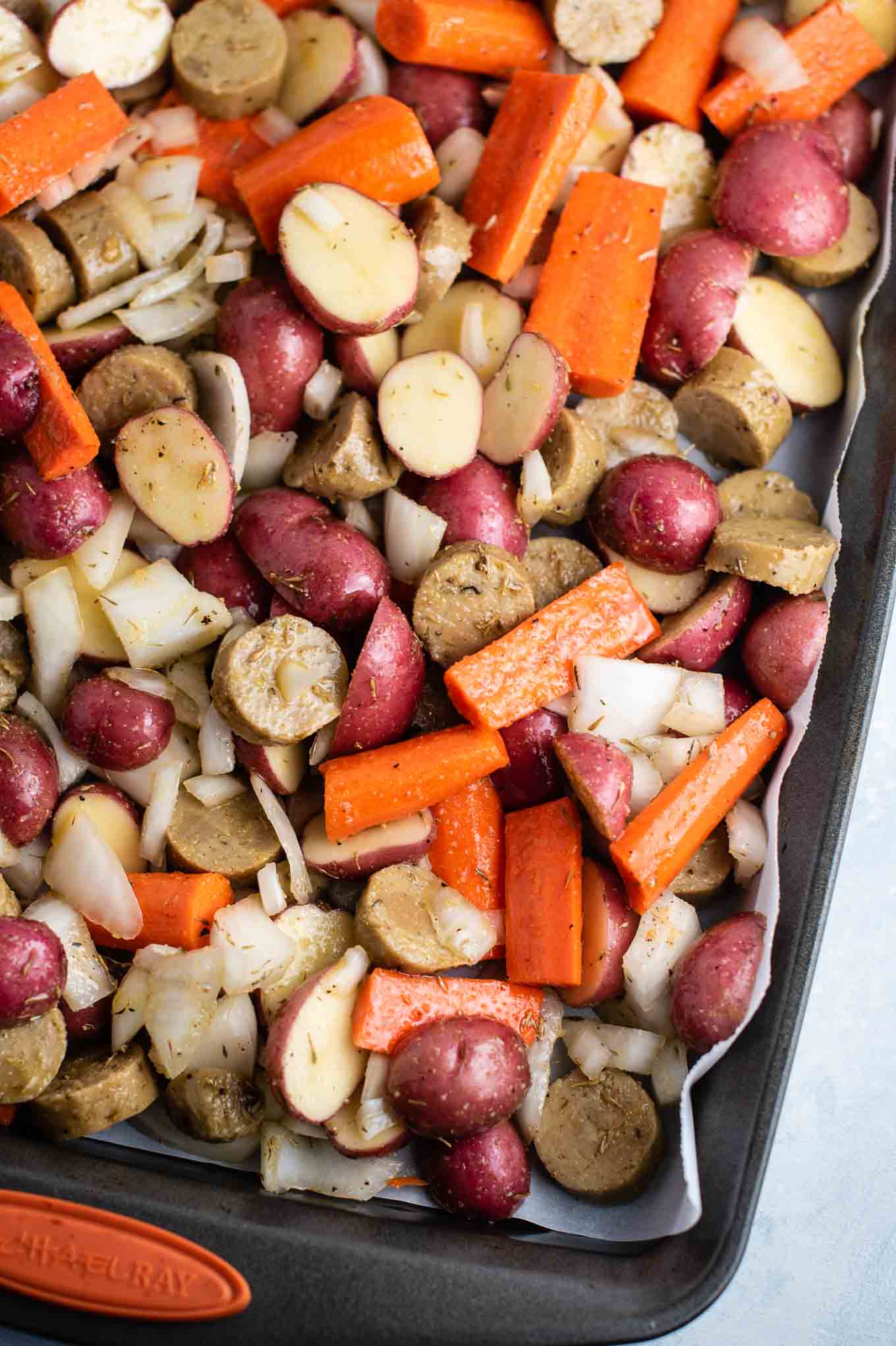 sheet pan with all ingredients mixed with the spices and oil prior to baking