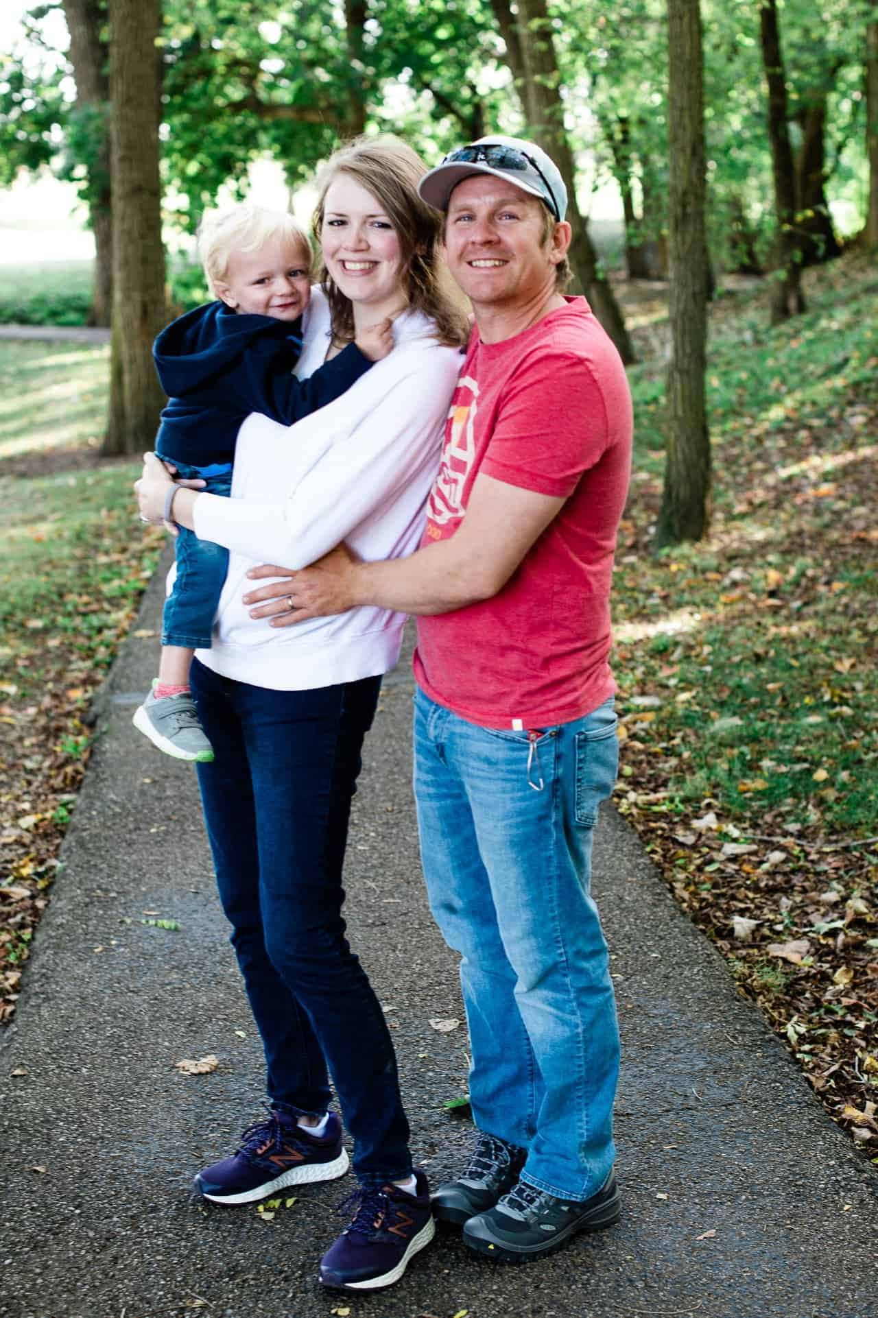 mom, dad, and three year old smiling 