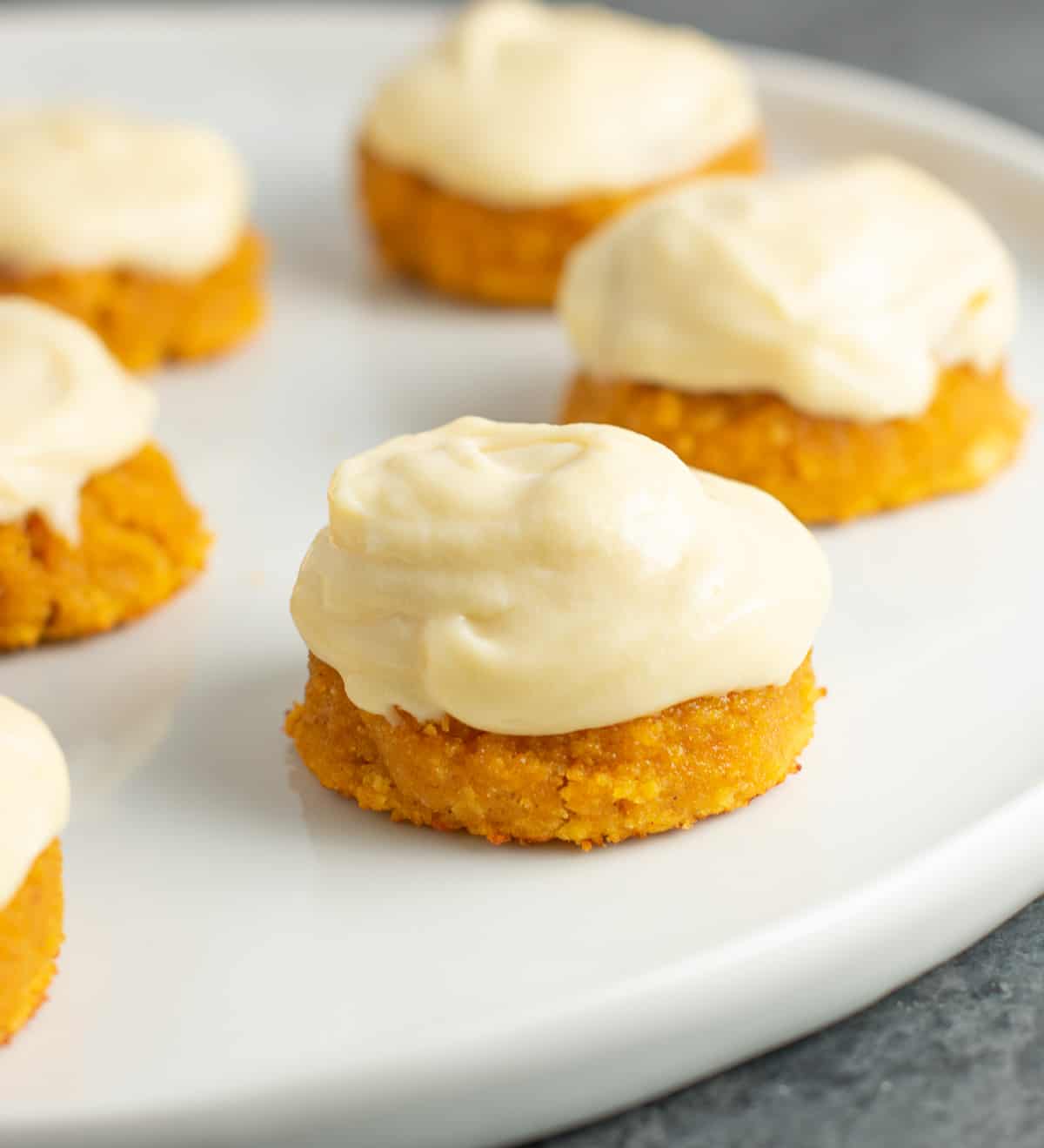 gluten free pumpkin cookies with cream cheese frosting on a plate 