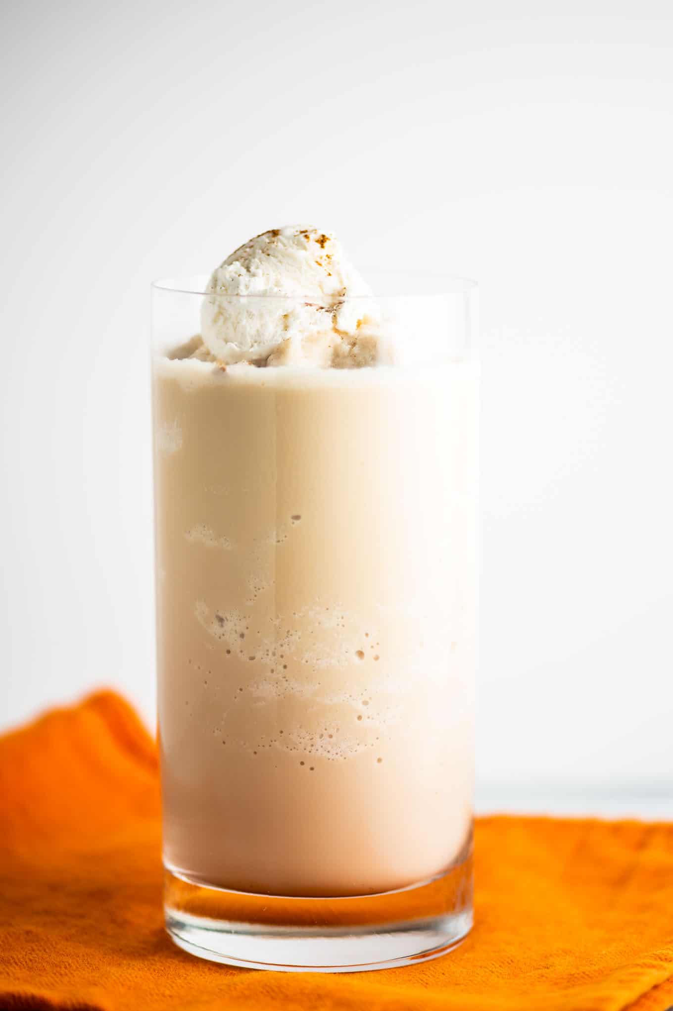 pumpkin spice frozen coffee in a clear tall glass