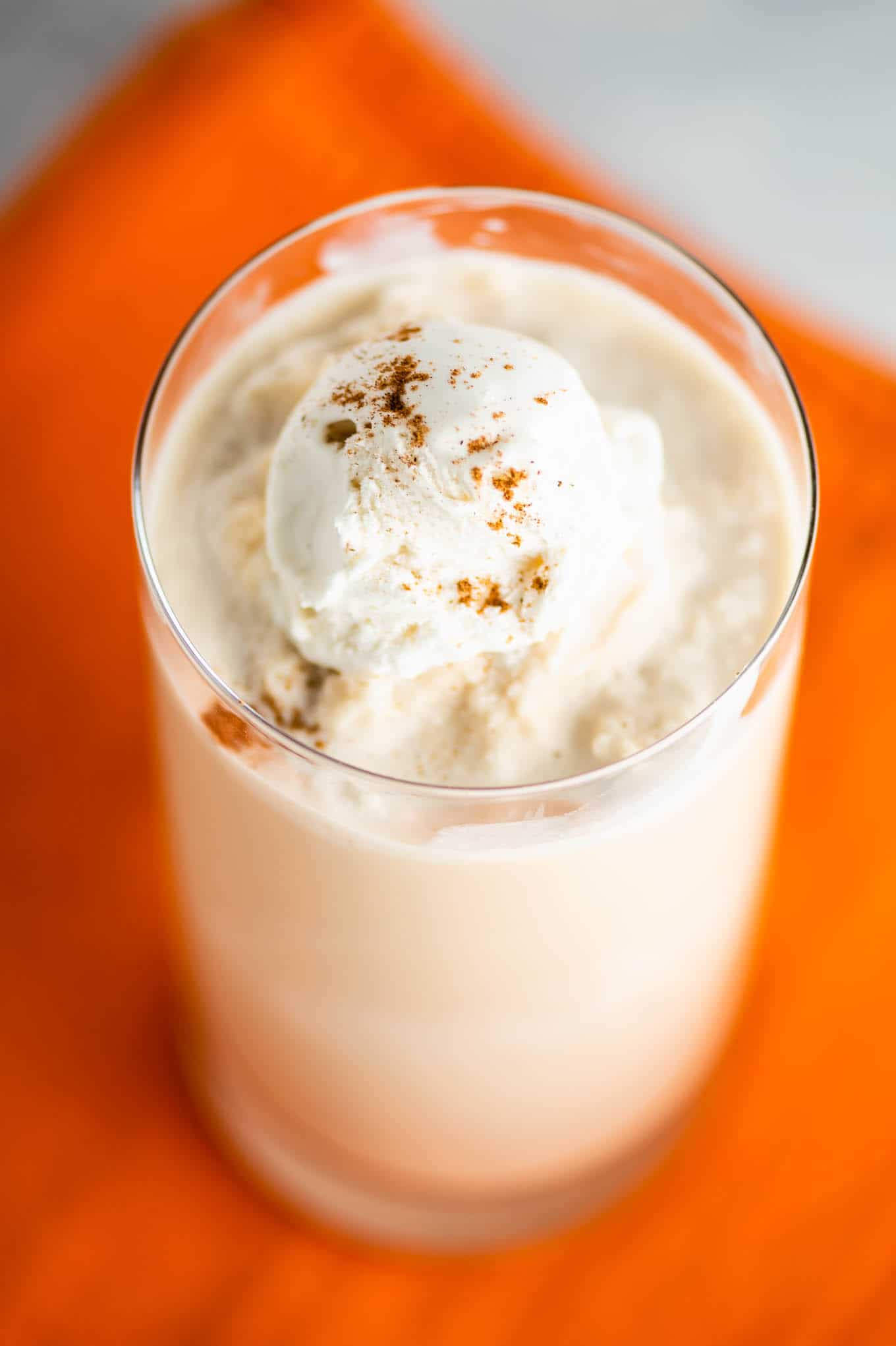 pumpkin coffee drink sitting on an orange napkin