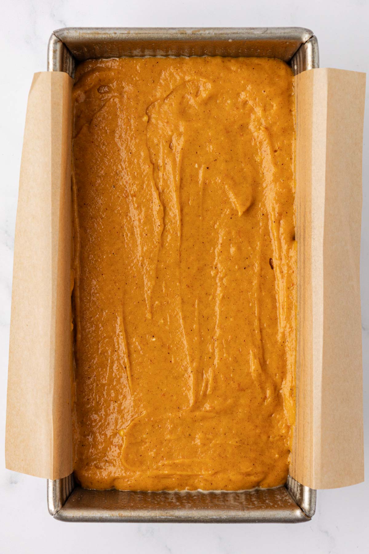 pumpkin bread batter in a loaf pan