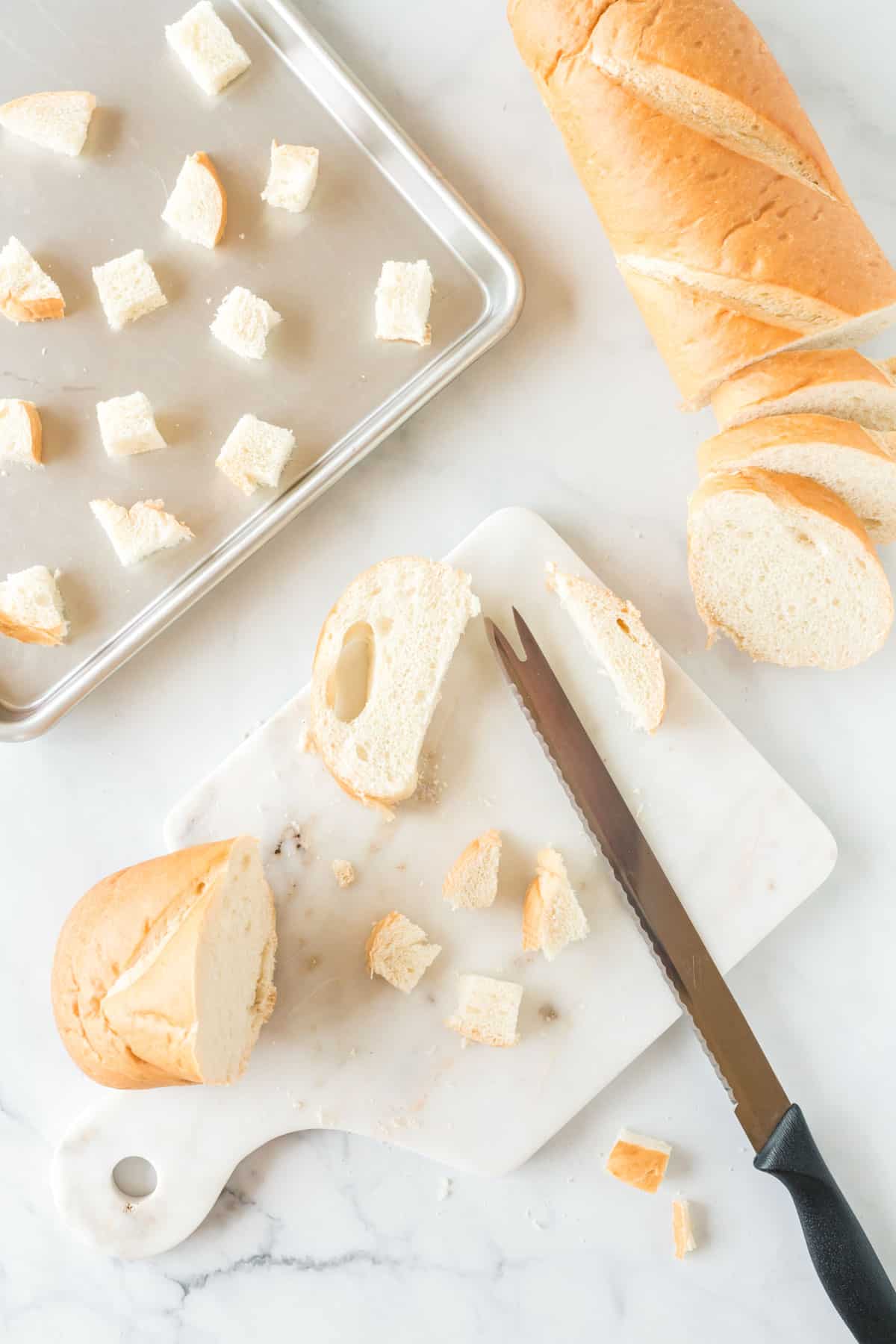 cutting a loaf of bread into cubes