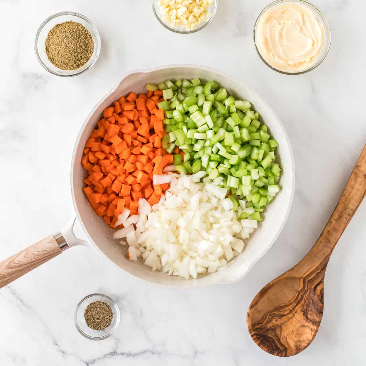 celery, carrots, and onion in a skillet