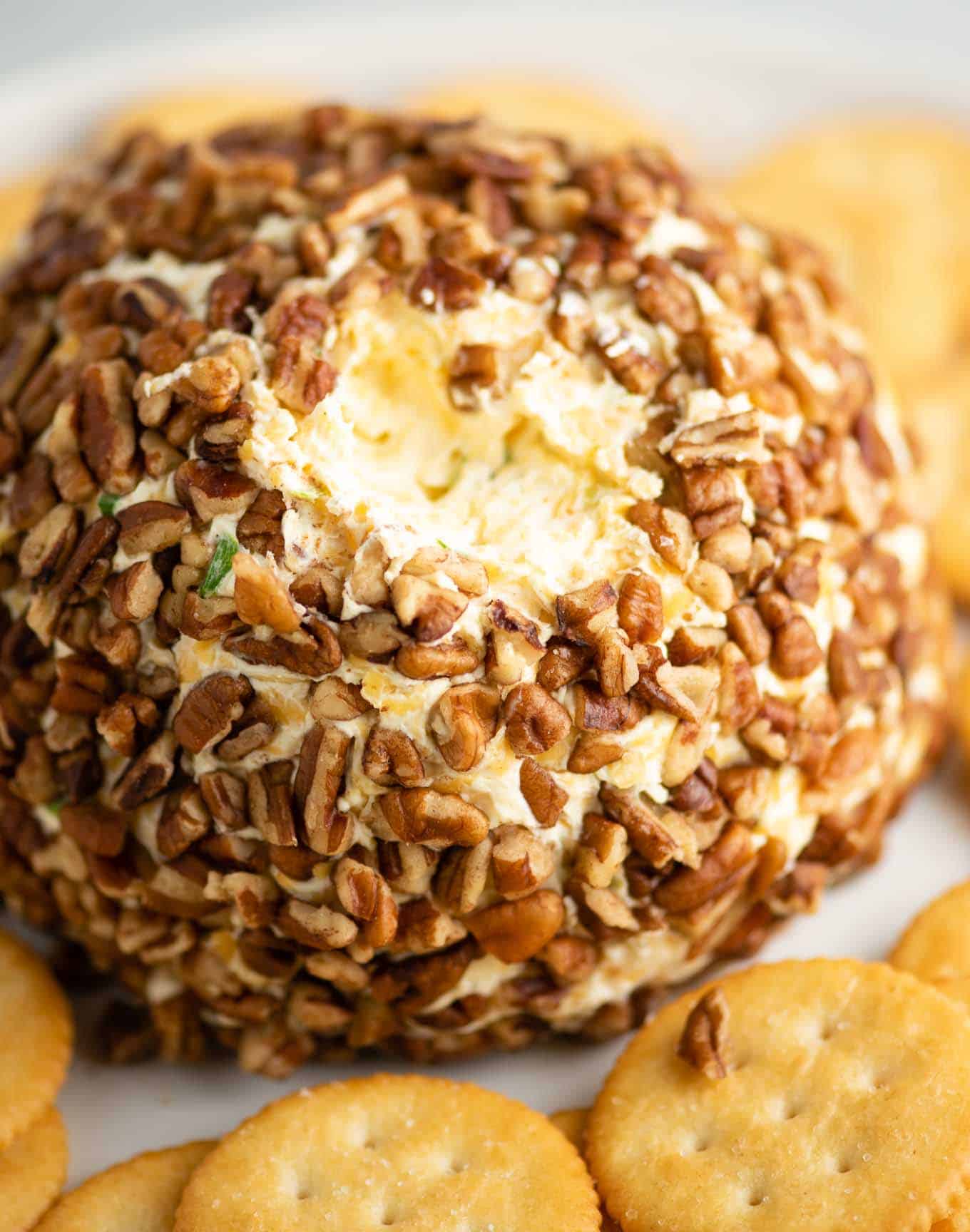 sour cream and cream cheese ball with a bite taken out of the top