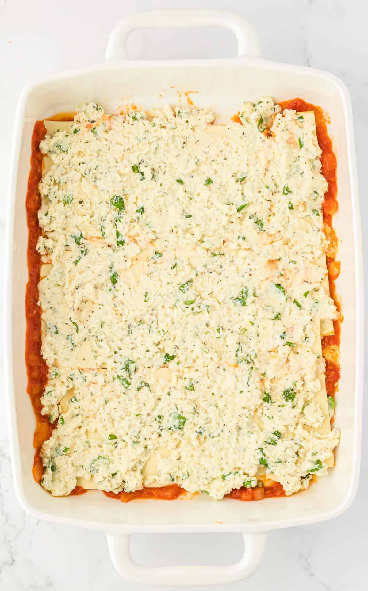 ricotta filling spread over lasagna noodles
