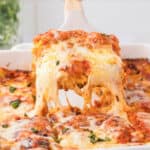 taking a piece of cheese lasagna from the pan