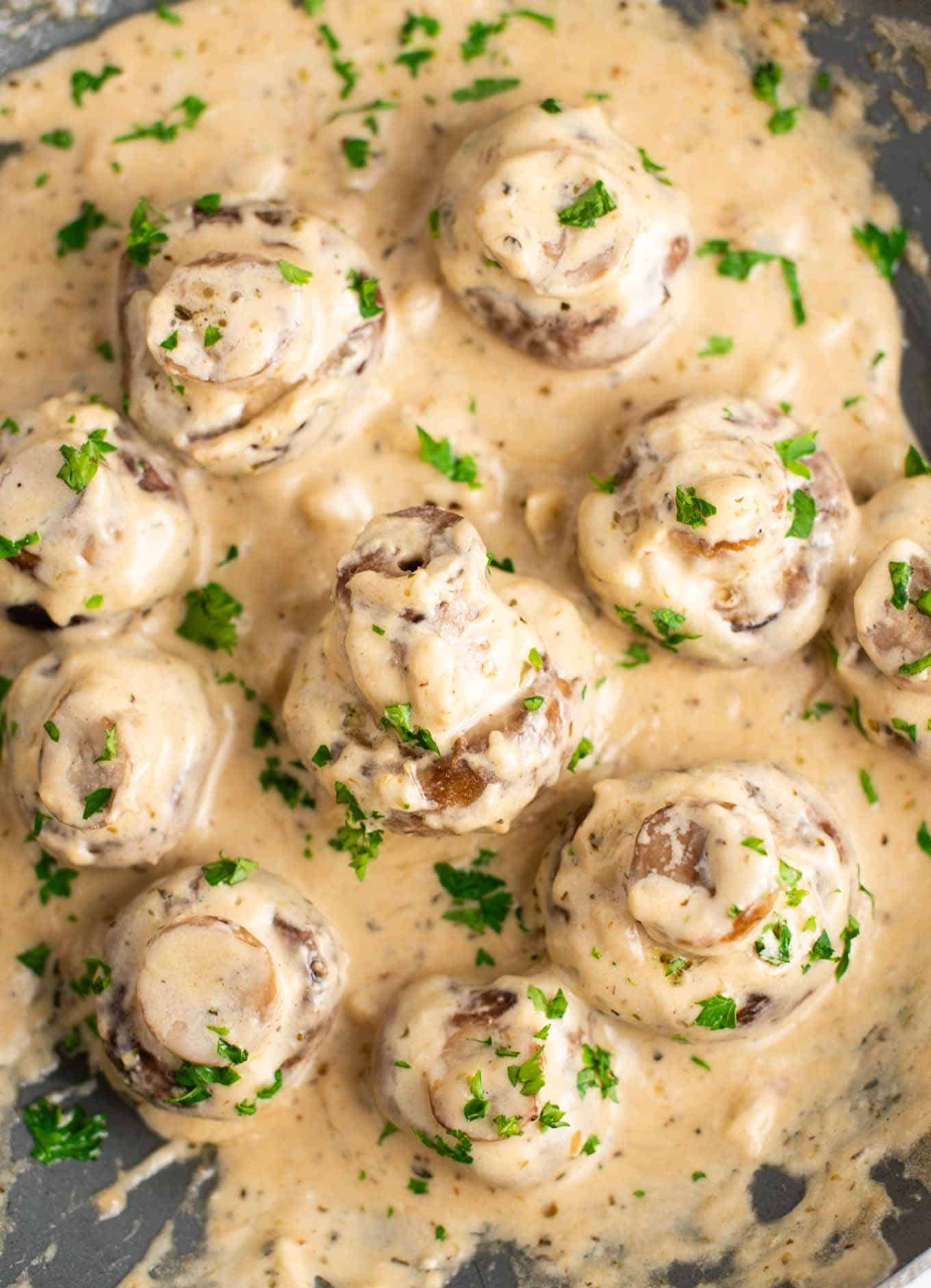 creamy garlic mushrooms in a skillet from an overhead view