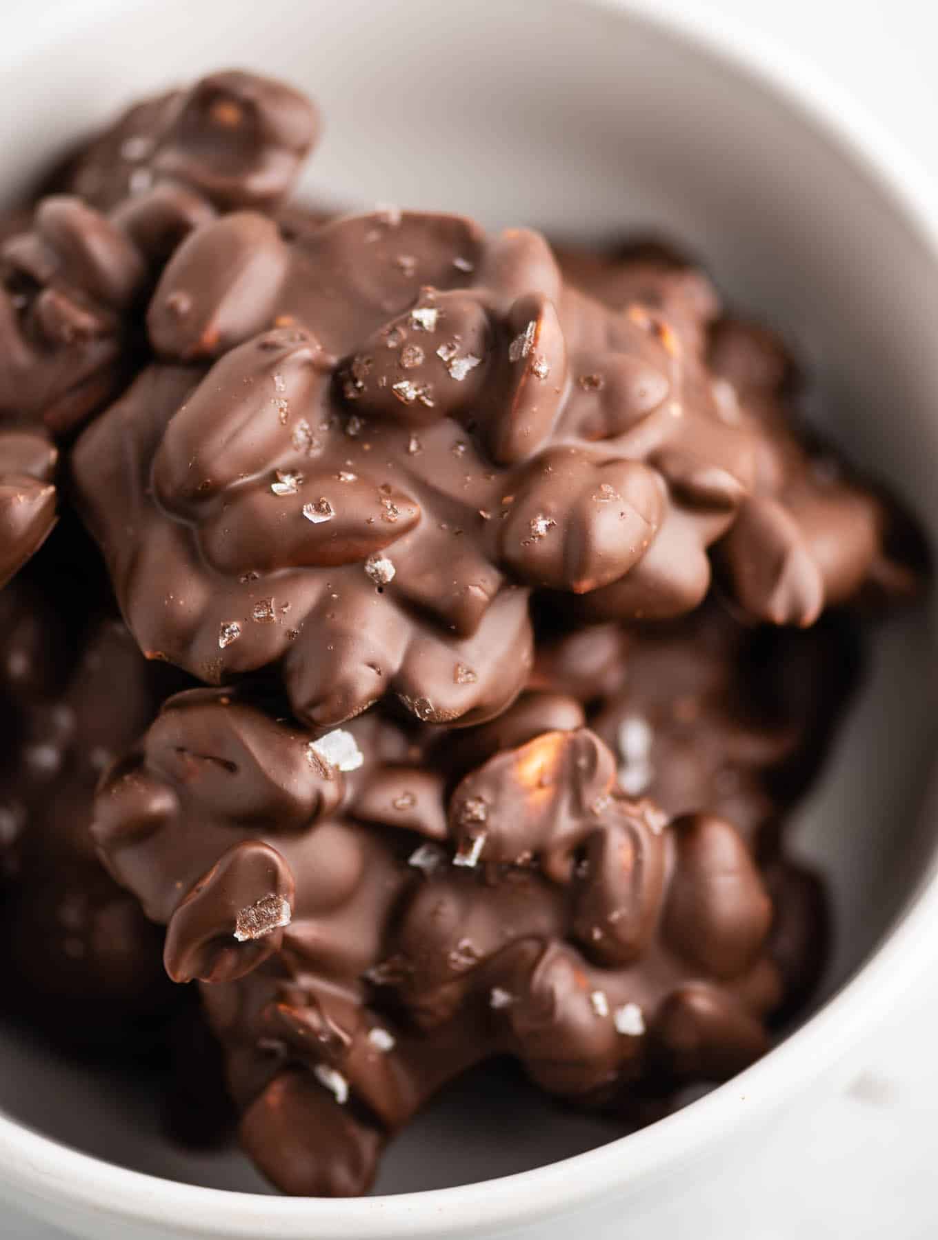 christmas chocolate peanut clusters in a white bowl