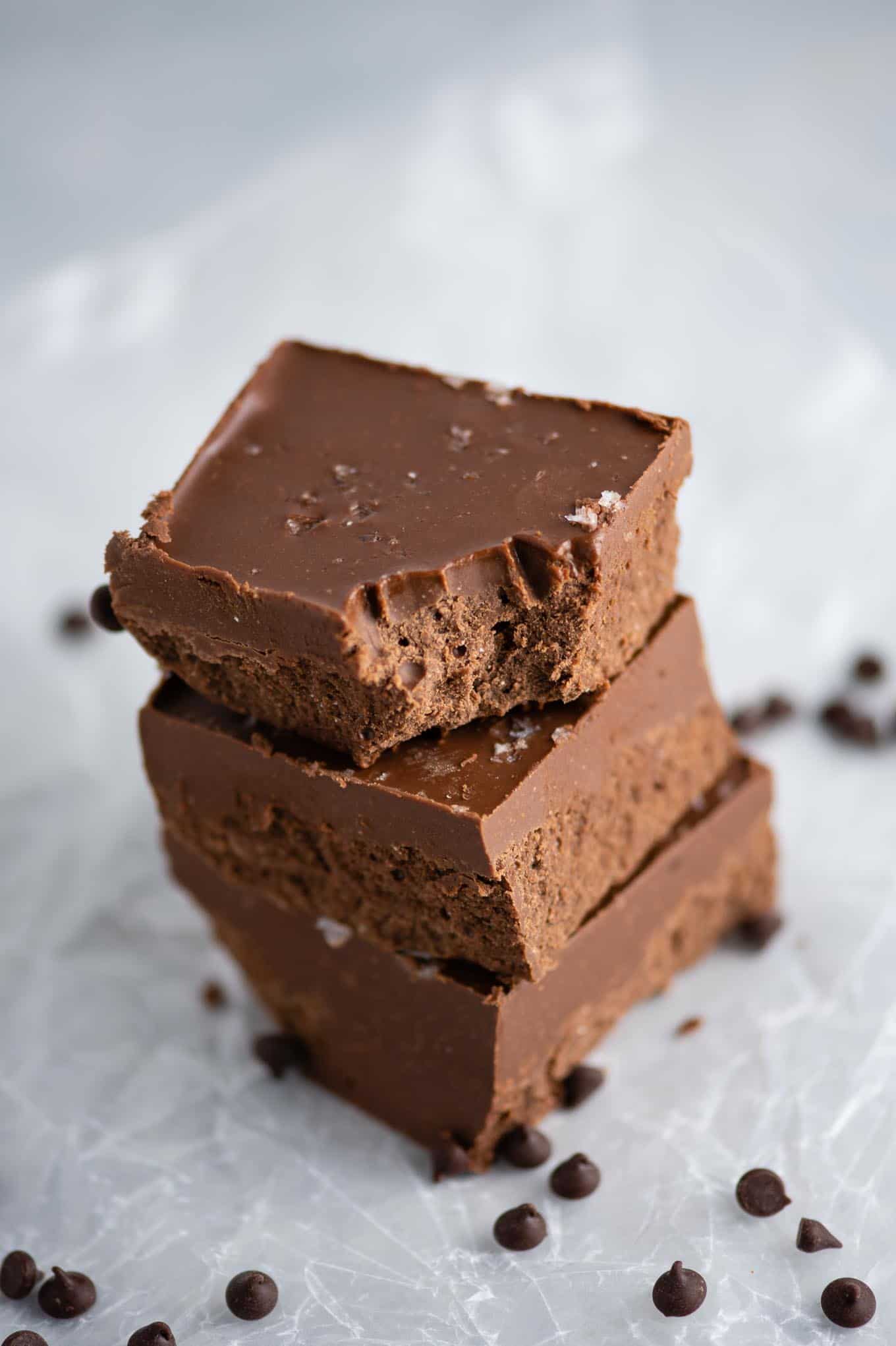 vegan chocolate peanut butter fudge stacked with a bite taken out