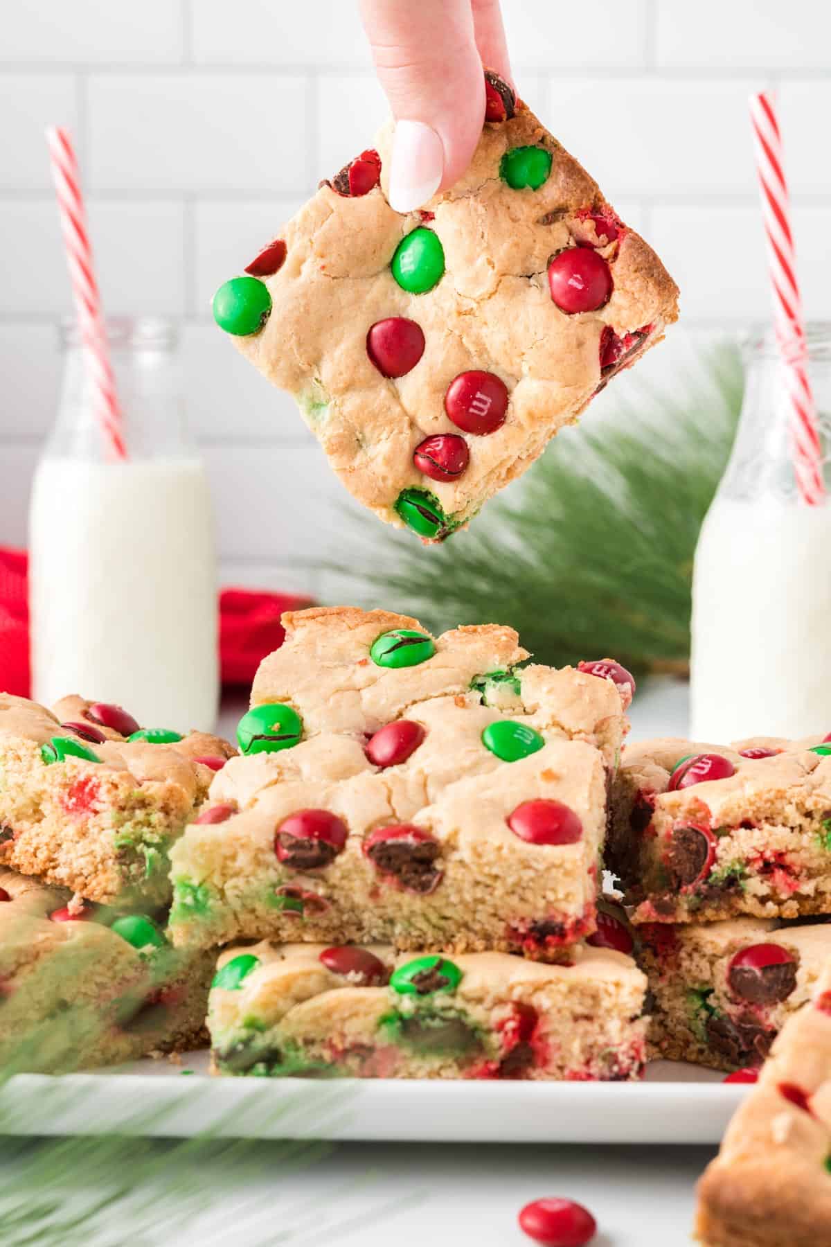 holding a cookie bar above the serving dish