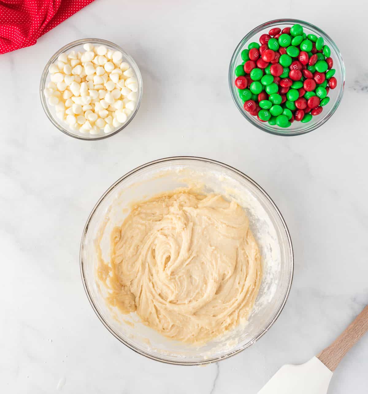 cake mix batter next to white chocolate chips and Christmas M&M's