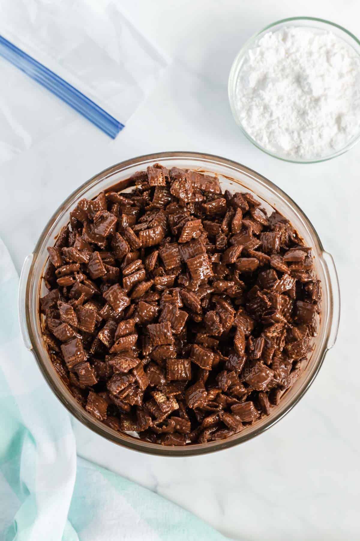 rice chex coated in the melted chocolate and peanut butter