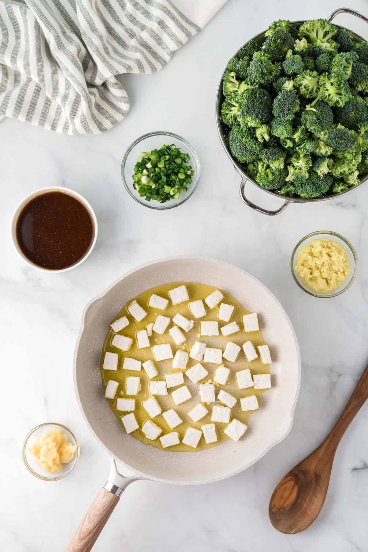 tofu cooking in a skillet surrounded with the other recipe ingredients