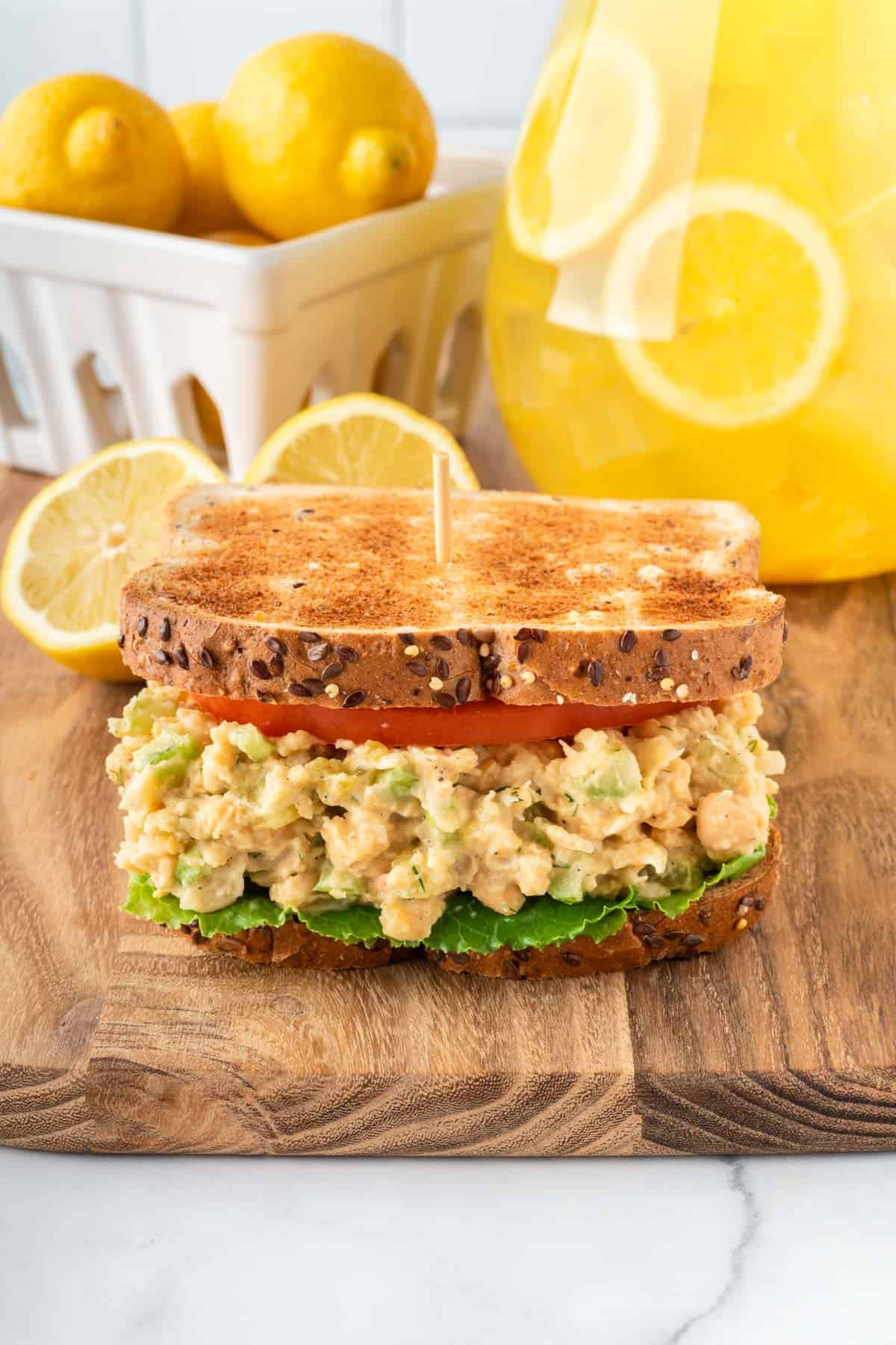 chickpea salad sandwich on bread with tomato and lettuce