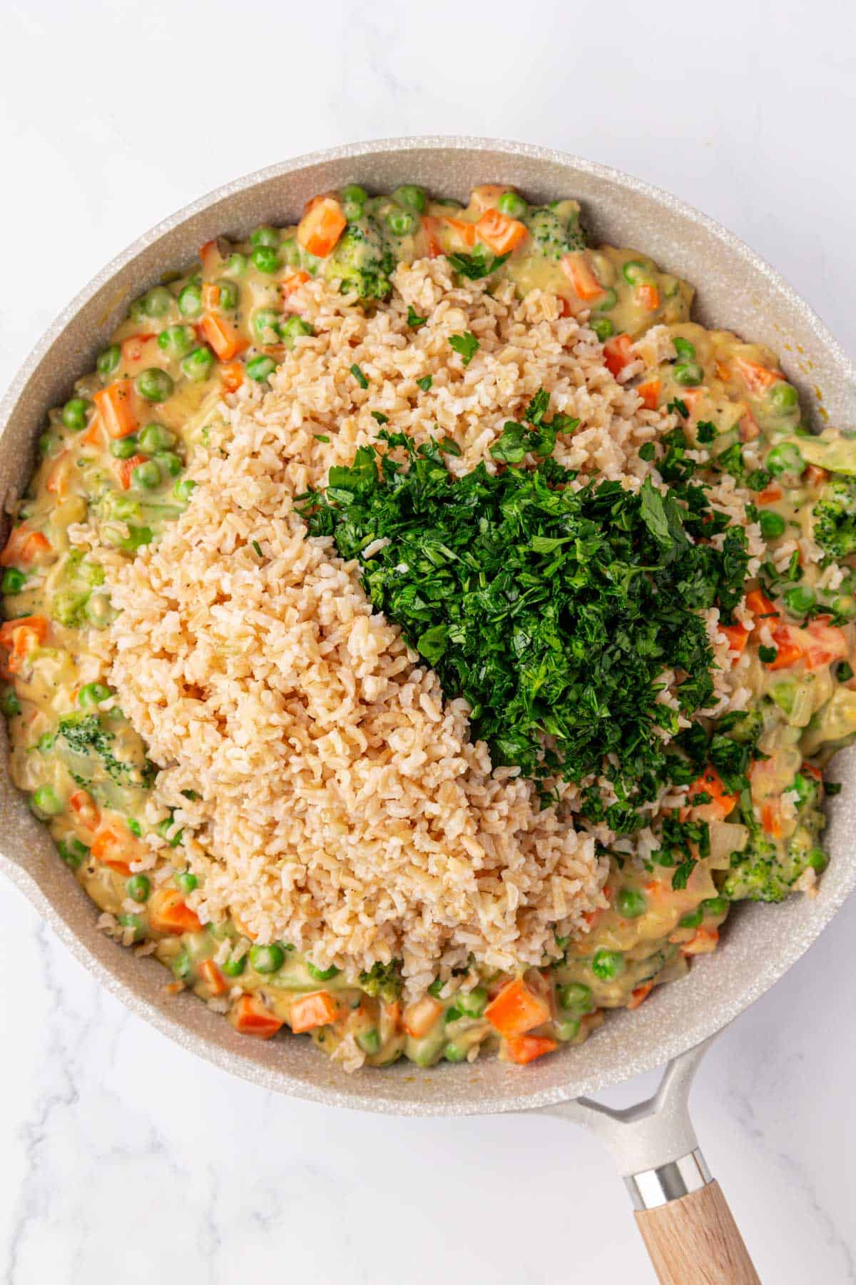 adding the parsley and brown rice to the vegetables