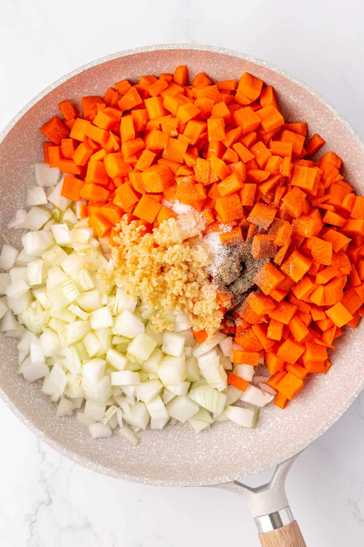 carrots, onions, garlic, and spices in a skillet