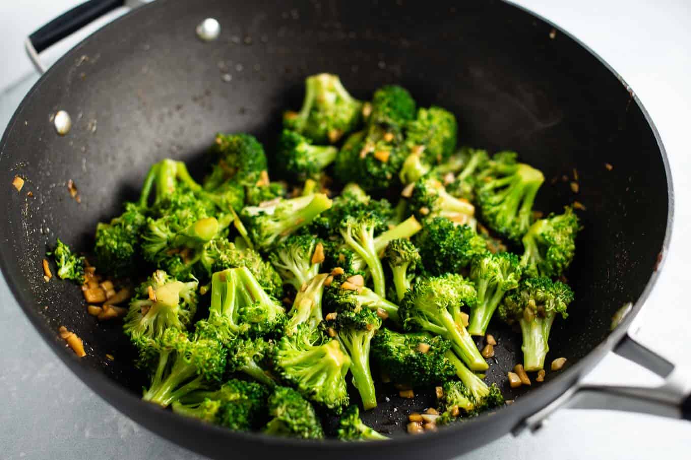 broccoli stir fried in a black skillet