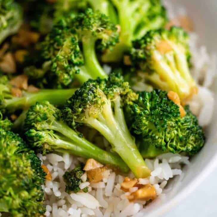 broccoli stir fry over rice in a white bowl