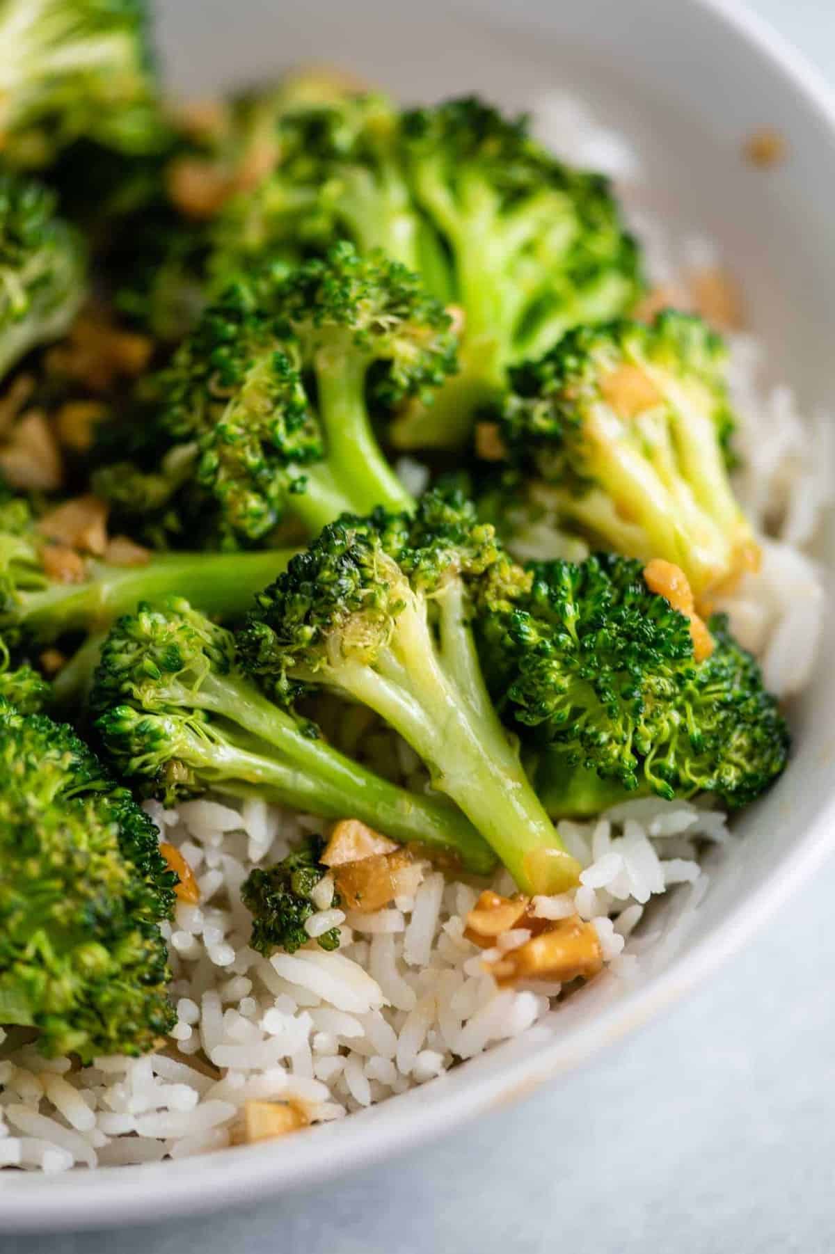 broccoli stir fry over rice in a white bowl