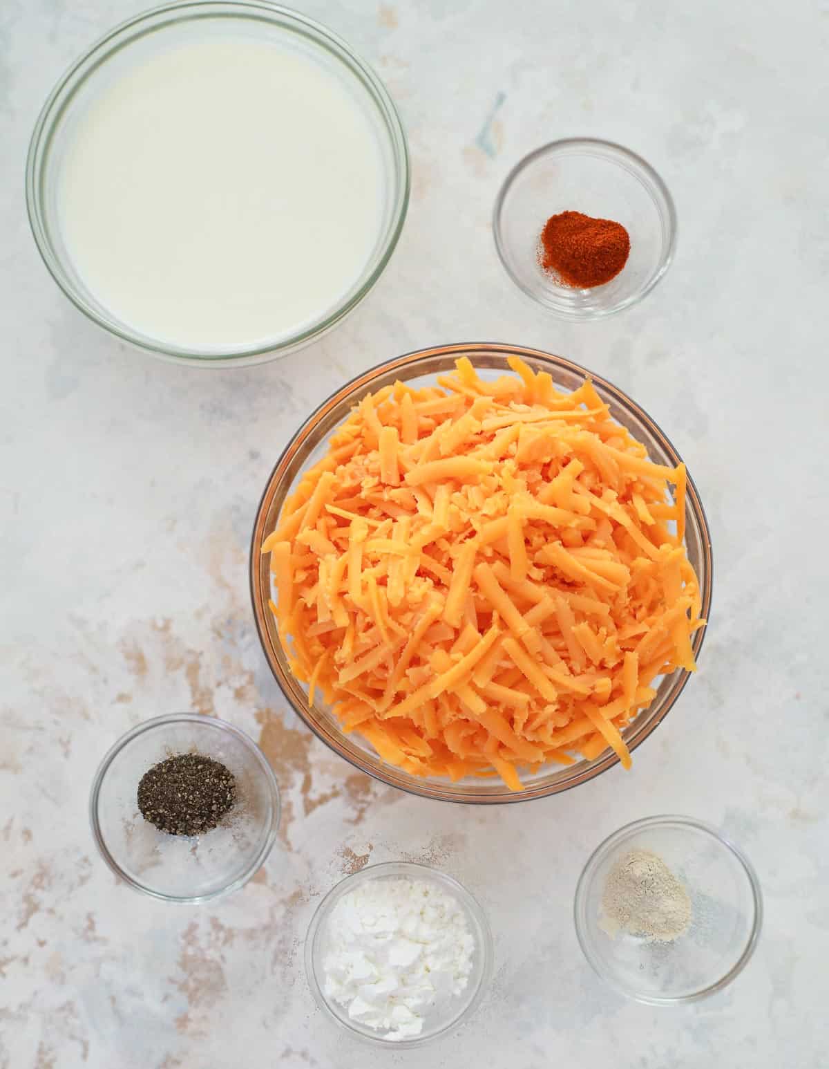 cheese sauce ingredients in separate glass bowls