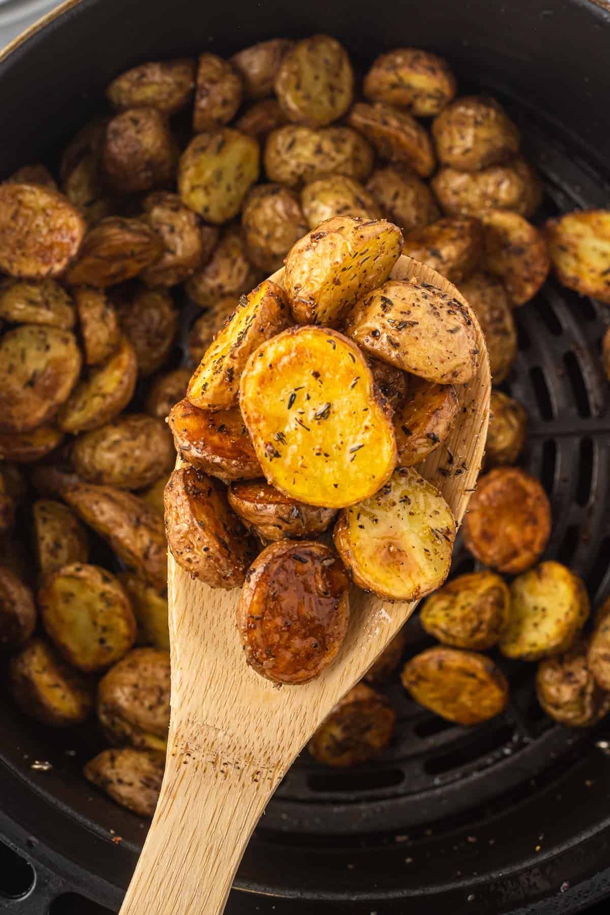 air fryer potatoes on a wooden spoon