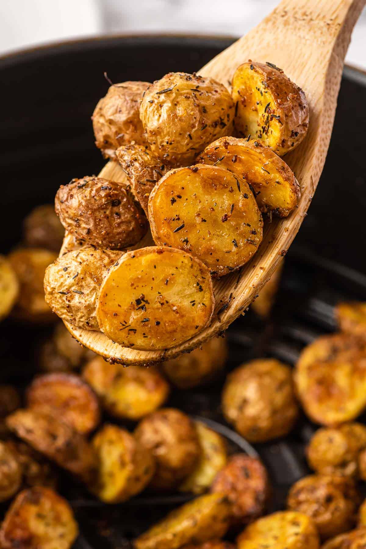 air fryer potatoes on a wooden spoon