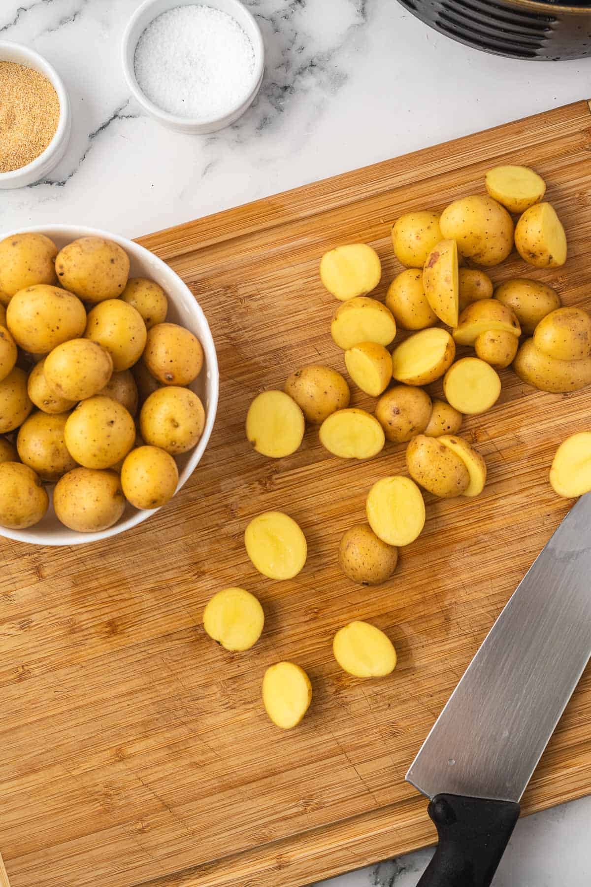 baby potatoes cut in half on a cutting board