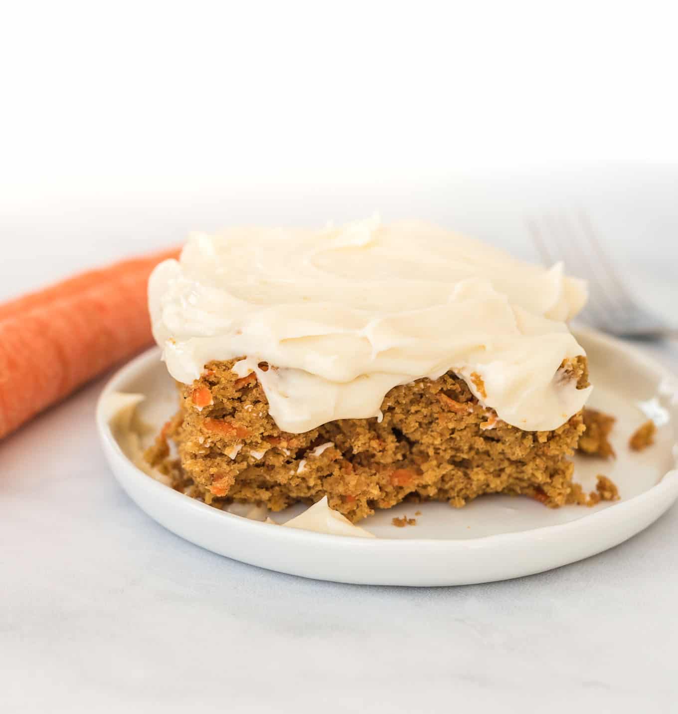 gluten free carrot cake slice on a white plate