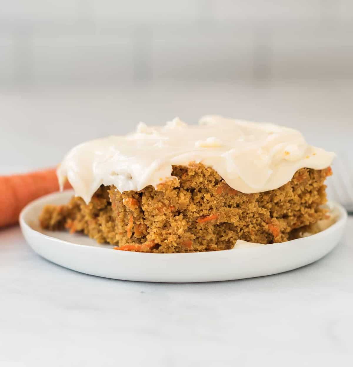 gluten free carrot cake slice on a white plate