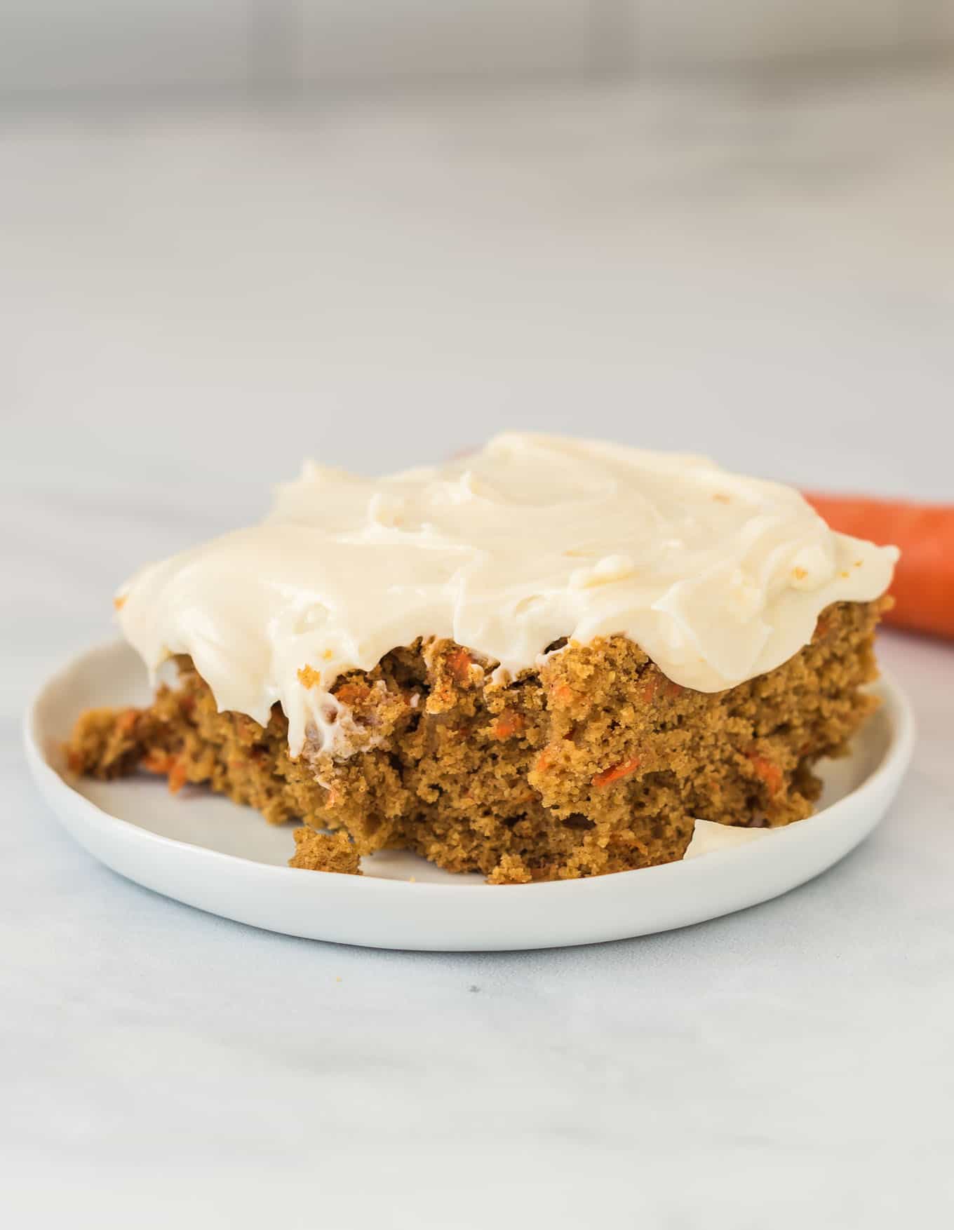 gluten free carrot cake slice on a white plate