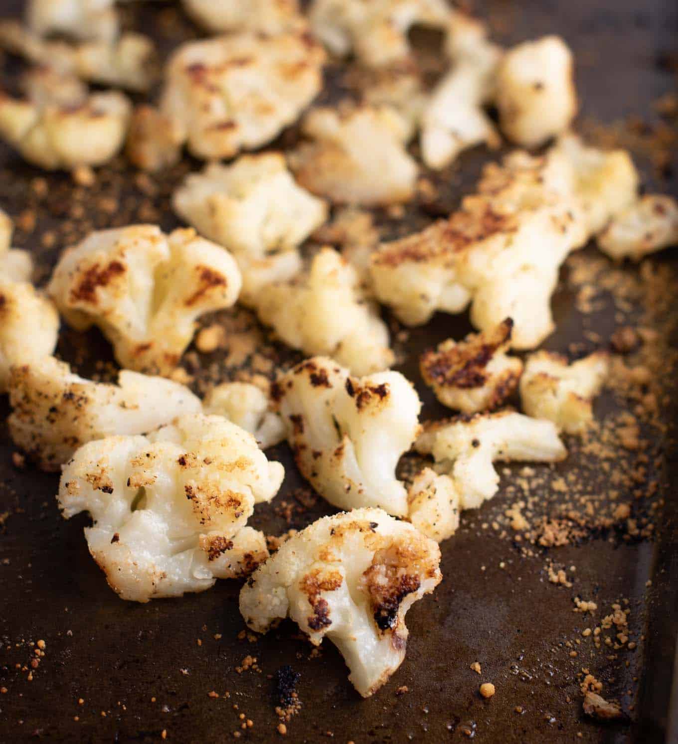 roasted cauliflower on a brown baking sheet