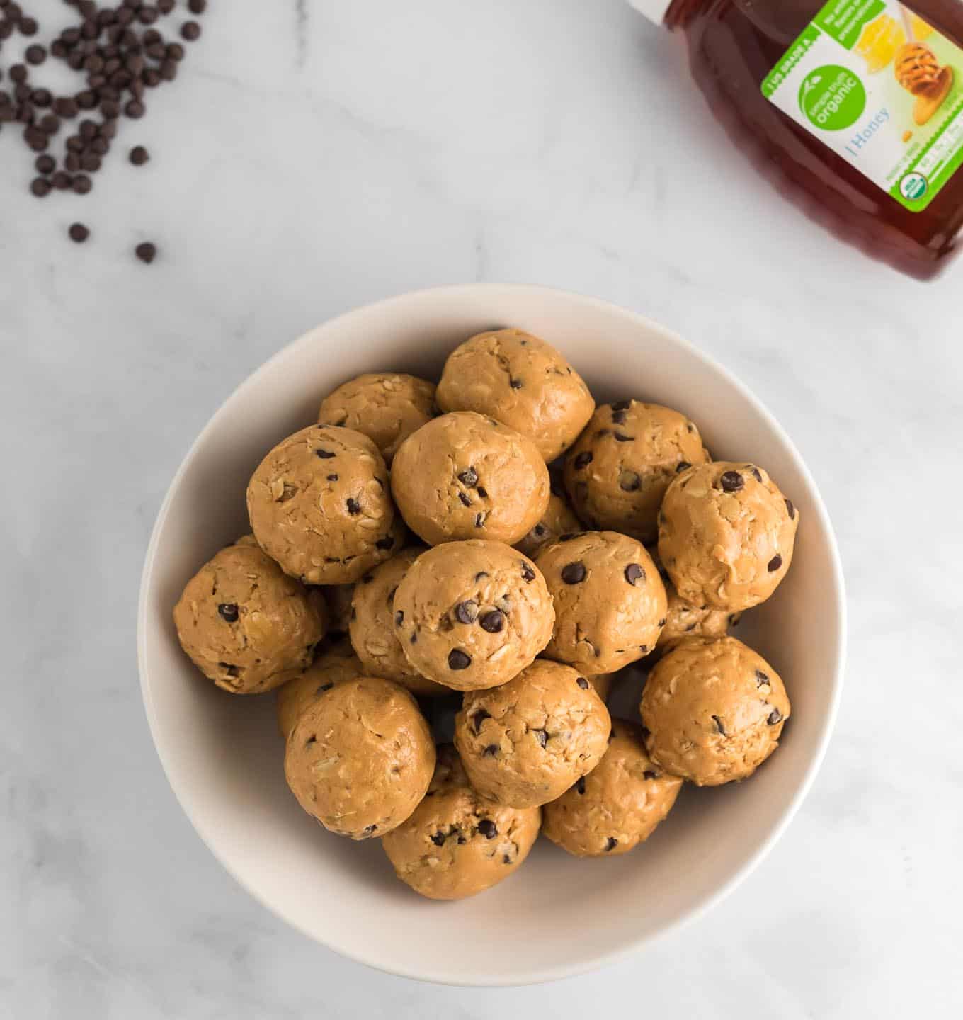 energy balls with honey and chocolate chips in the corner of the photo