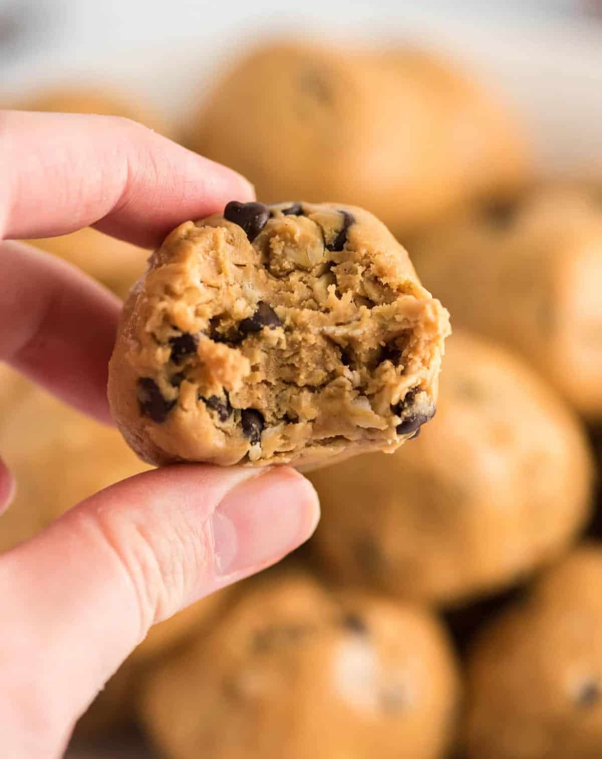 fingers holding up an energy ball with a bite taken out