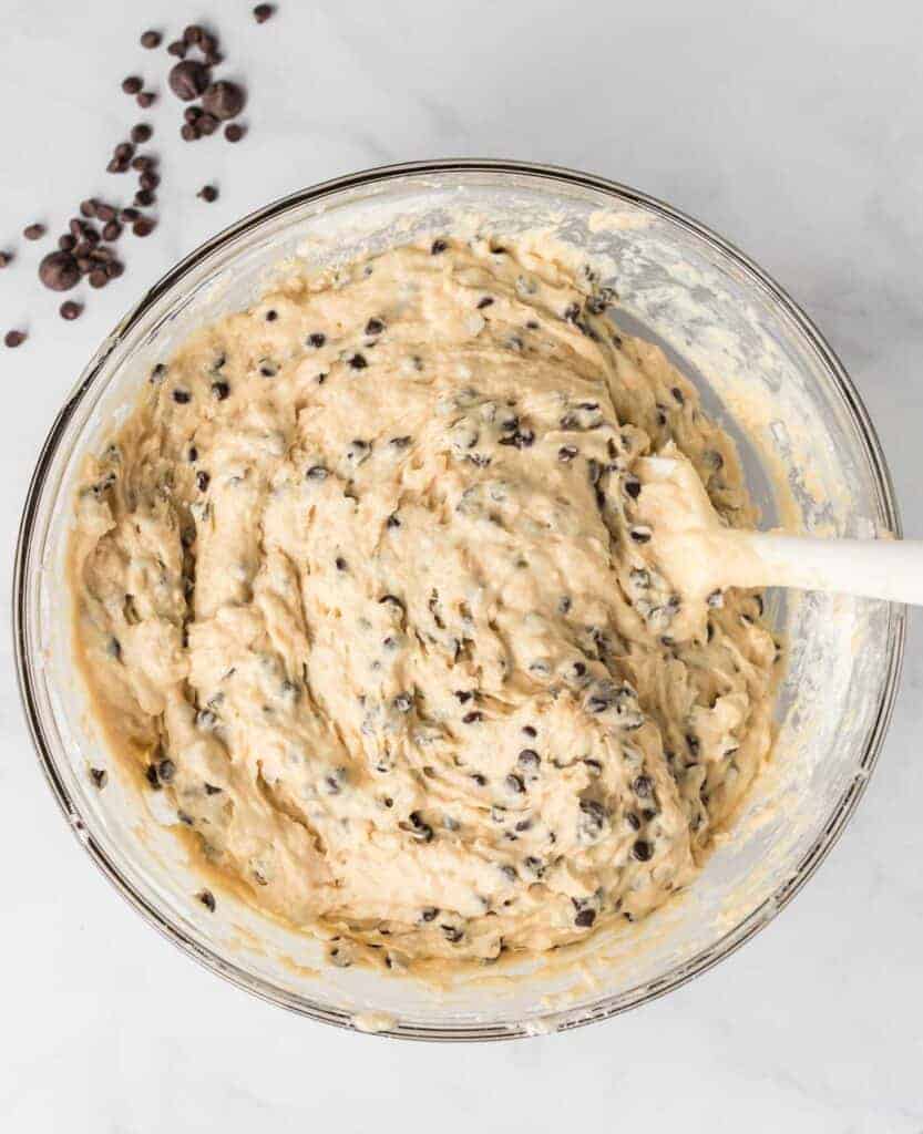 mixed together muffin batter in a bowl with rubber spatula