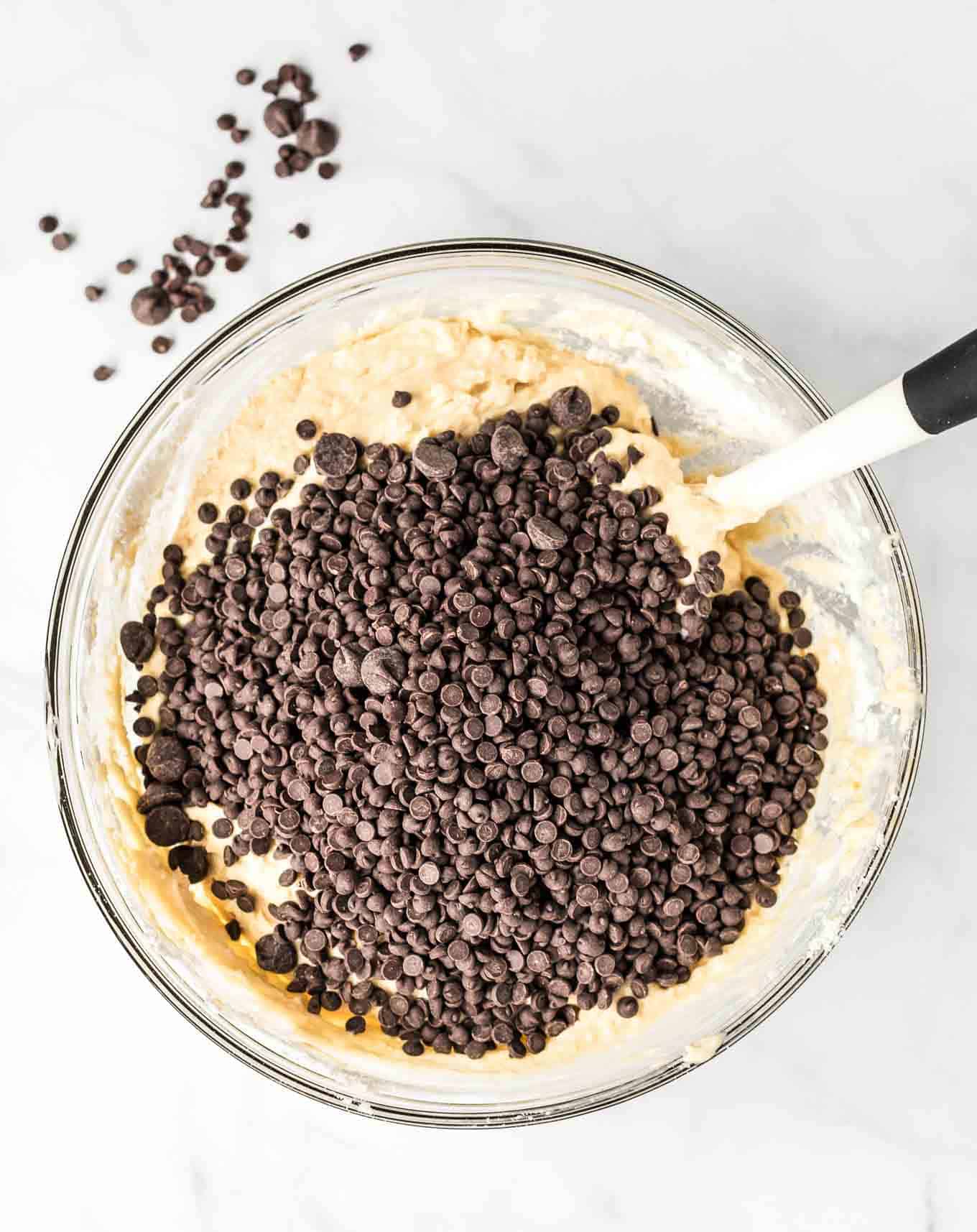 a mixing bowl with batter and topped with mini chocolate chips