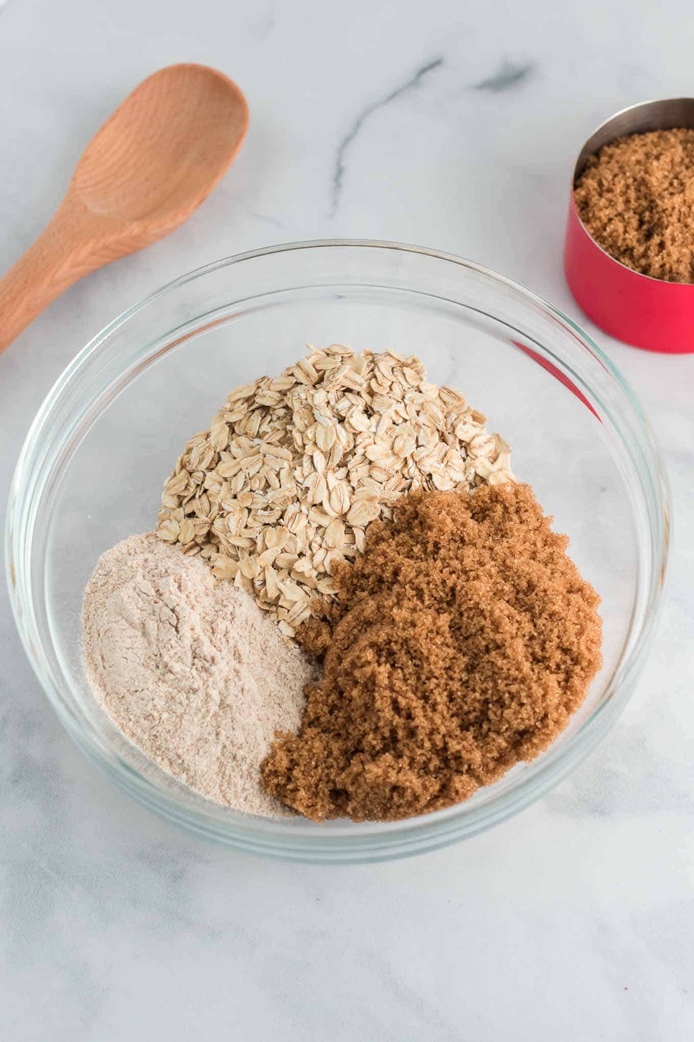 flour, oats, and brown sugar in a clear mixing bowl