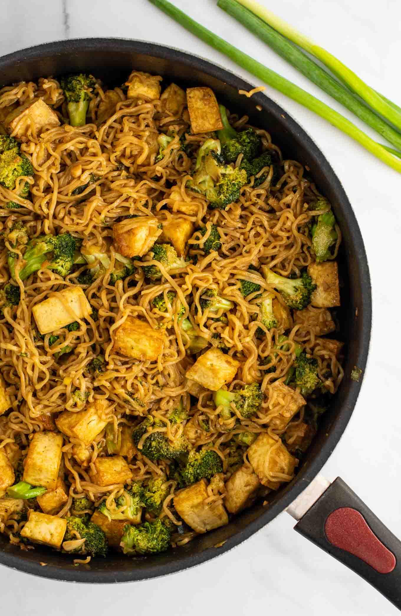 broccoli tofu ramen noodles in a skillet from an overhead view