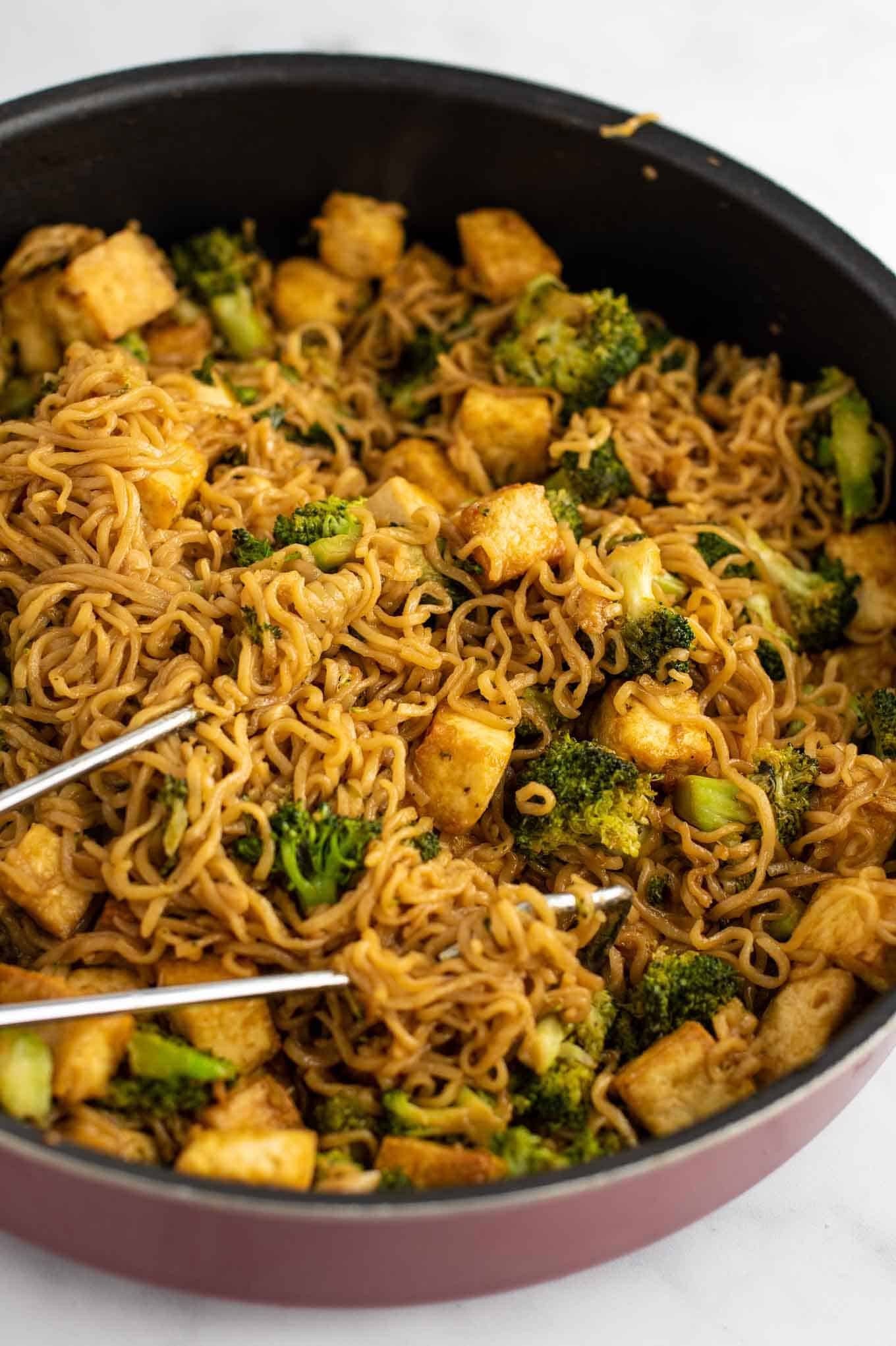 ramen noodle broccoli tofu stir fry in a pan from a side view